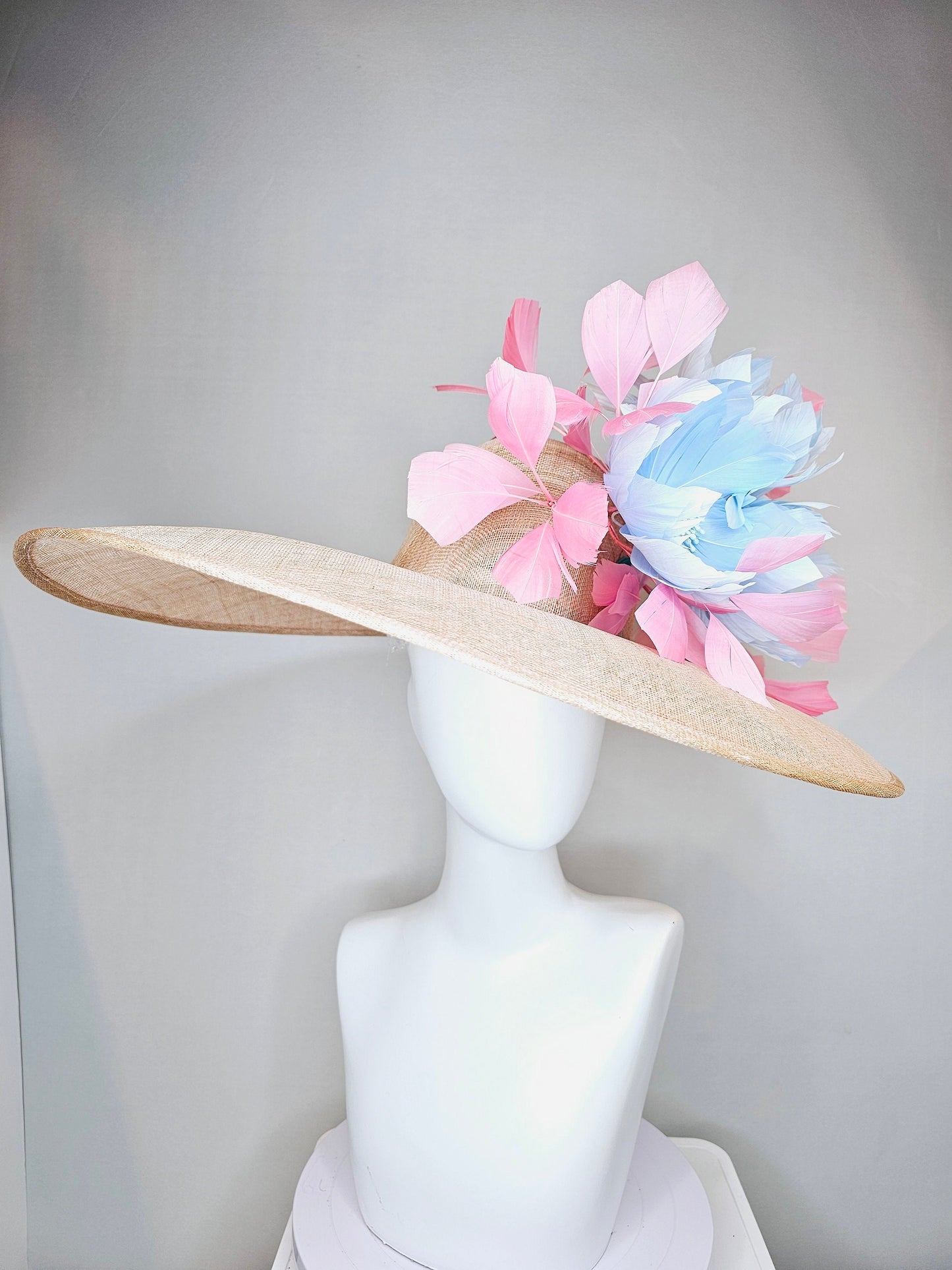 kentucky derby hat large wide brim sinamay neutral beige hat with light baby pink feathers and light baby blue fluffy feather flowers