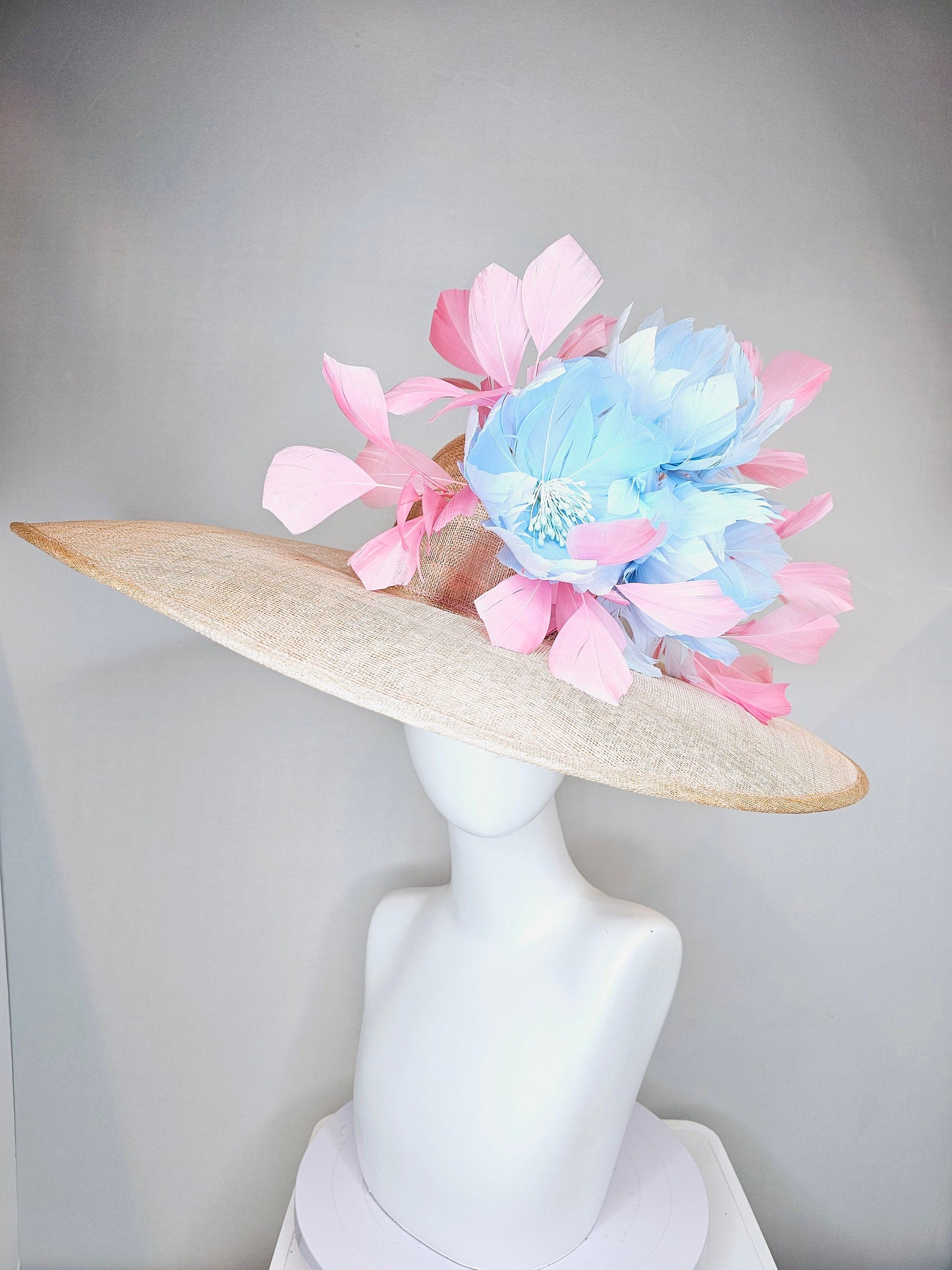 kentucky derby hat large wide brim sinamay neutral beige hat with light baby pink feathers and light baby blue fluffy feather flowers