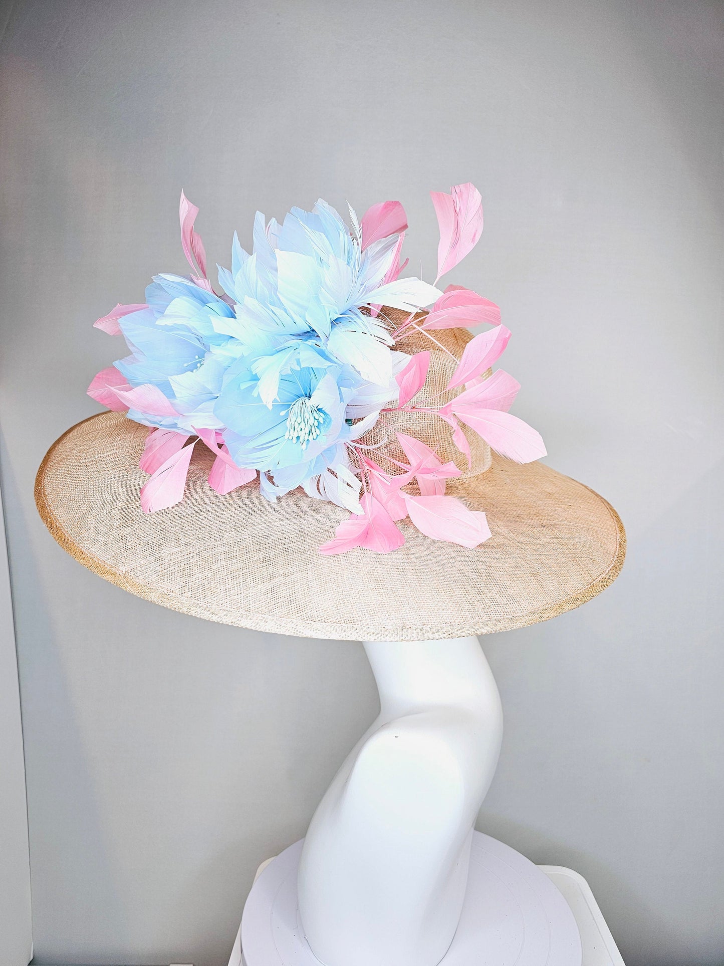 kentucky derby hat large wide brim sinamay neutral beige hat with light baby pink feathers and light baby blue fluffy feather flowers