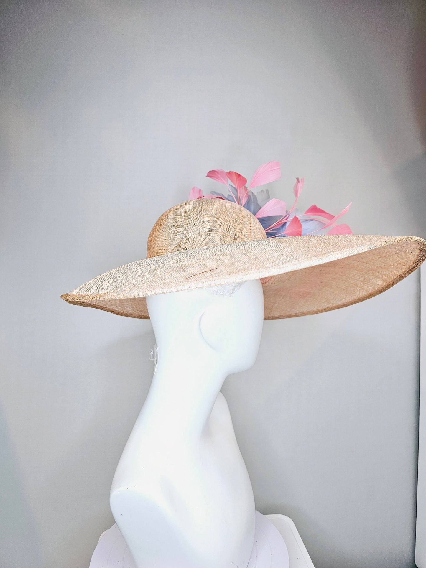 kentucky derby hat large wide brim sinamay neutral beige hat with light baby pink feathers and light baby blue fluffy feather flowers