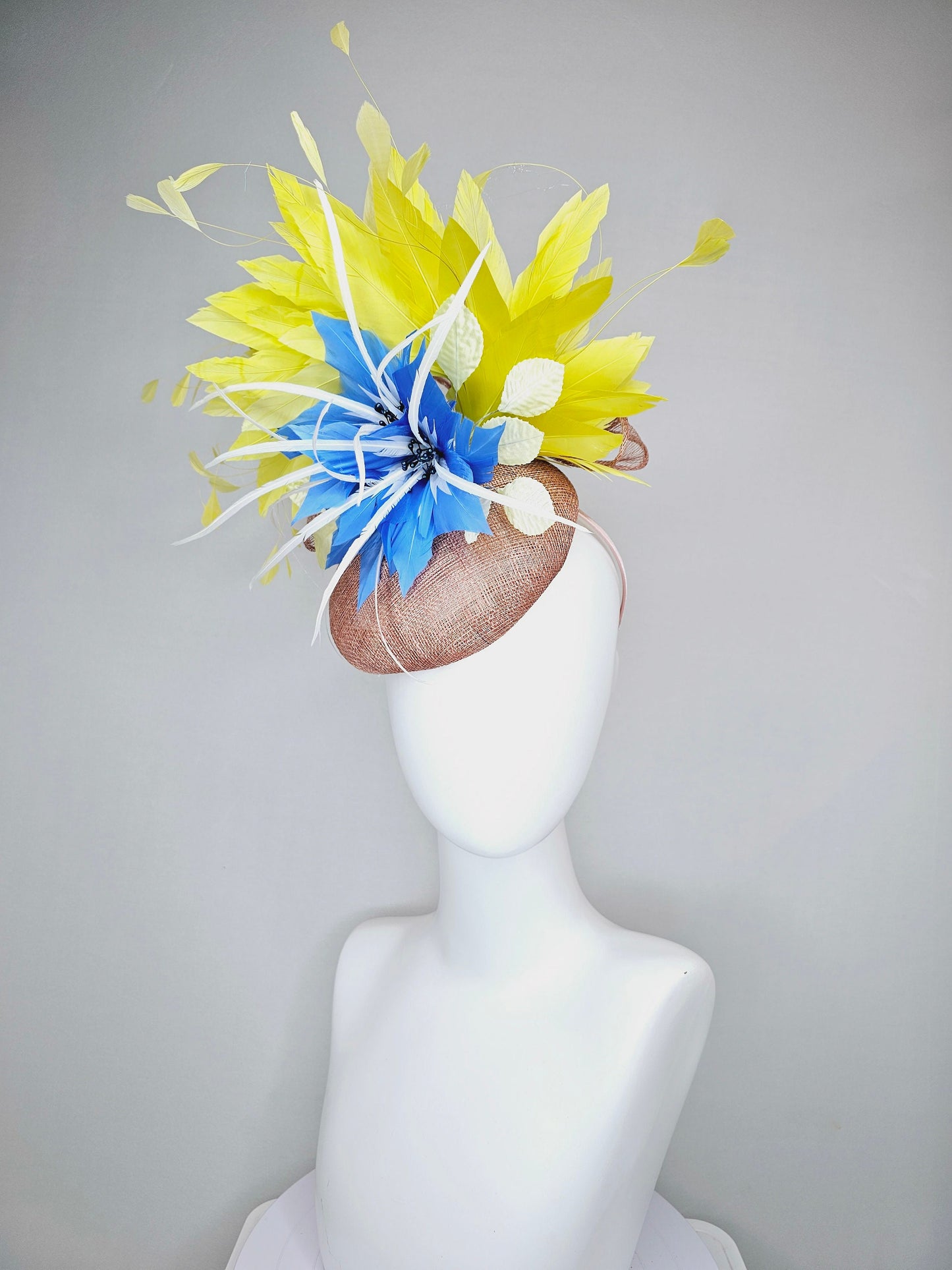 kentucky derby hat fascinator taupe neutral brown sinamay with bright yellow feathers and large blue feather flowers with white feathers