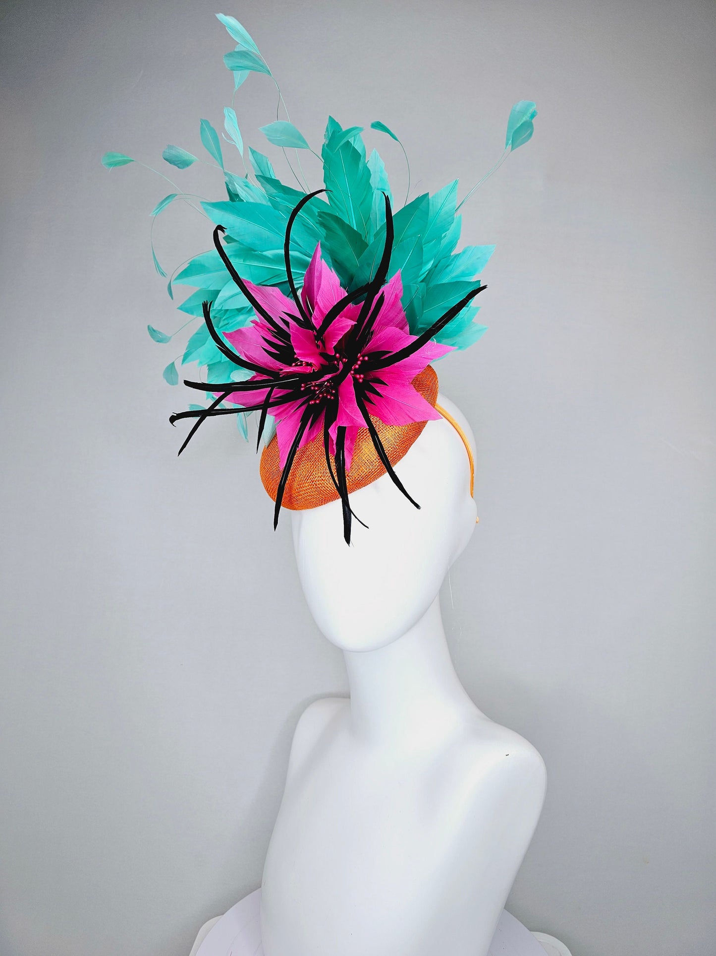 kentucky derby hat fascinator orange sinamay with large hot pink and black feather flowers and turquoise blue branching feathers