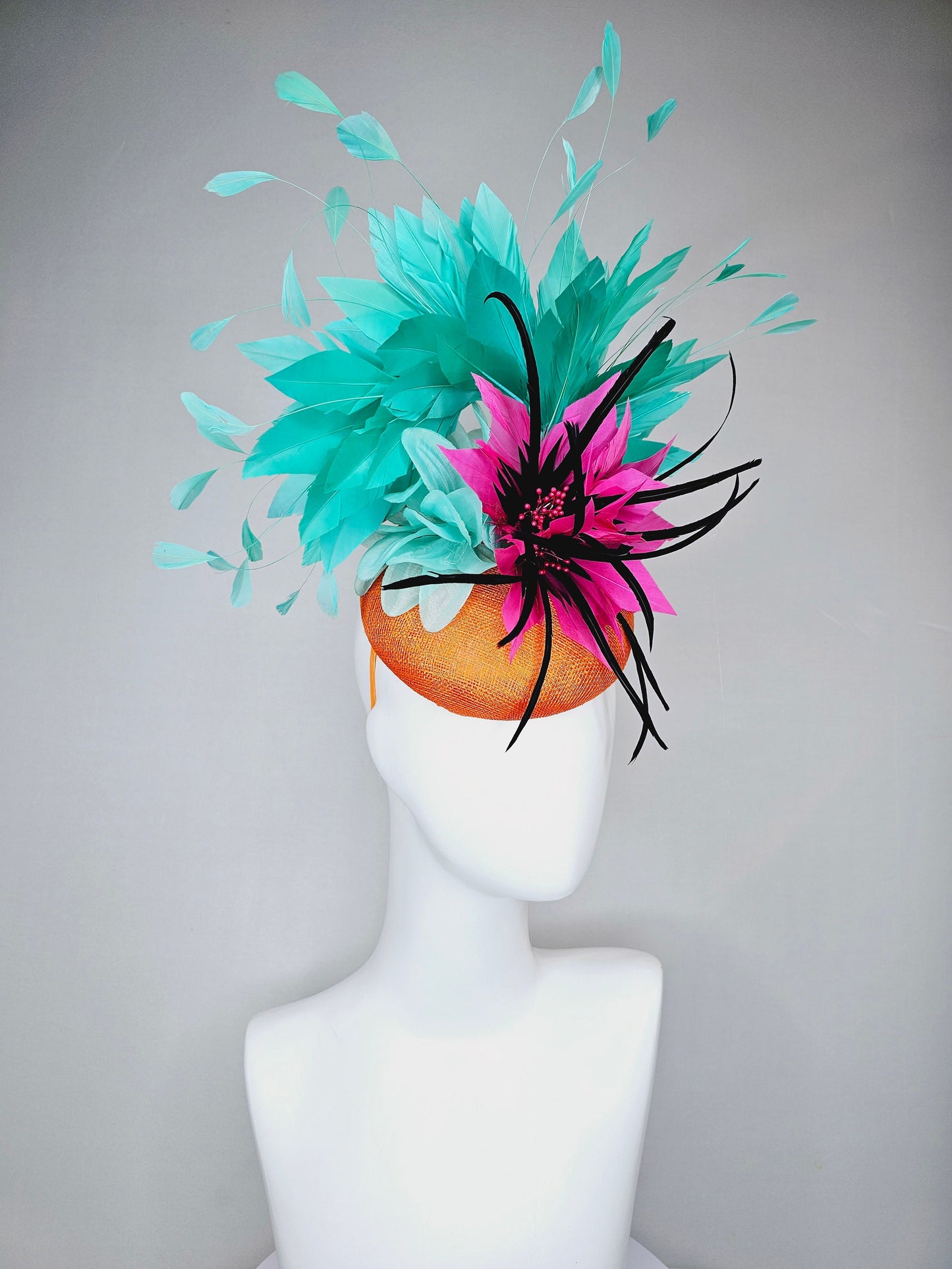 kentucky derby hat fascinator orange sinamay with large hot pink and black feather flowers and turquoise blue branching feathers