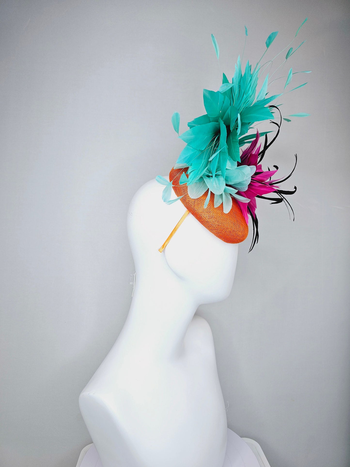 kentucky derby hat fascinator orange sinamay with large hot pink and black feather flowers and turquoise blue branching feathers