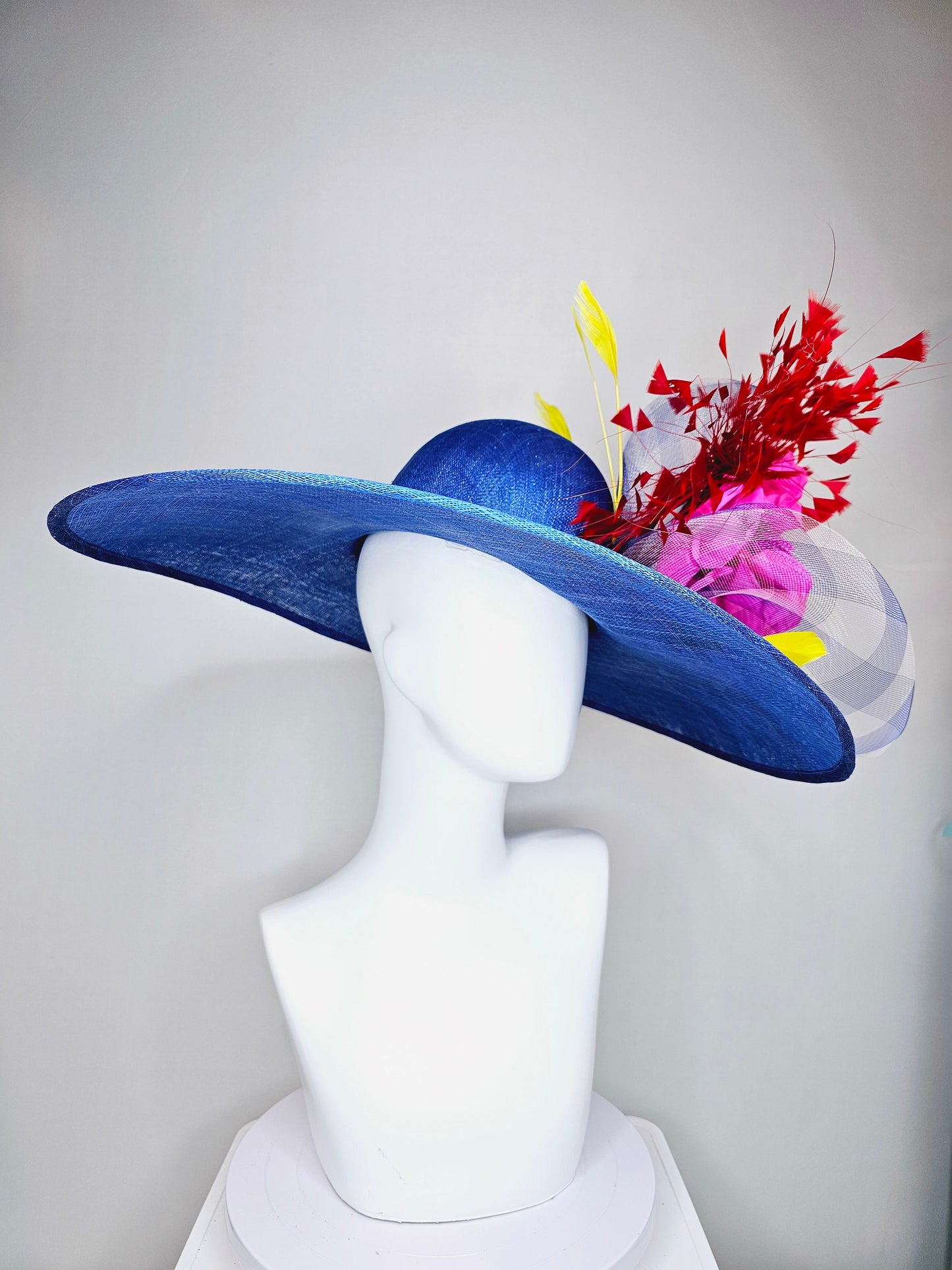 kentucky derby hat large wide brim sinamay royal blue hat with red and yellow feathers, bright pink satin flower w gingham plaid crinoline