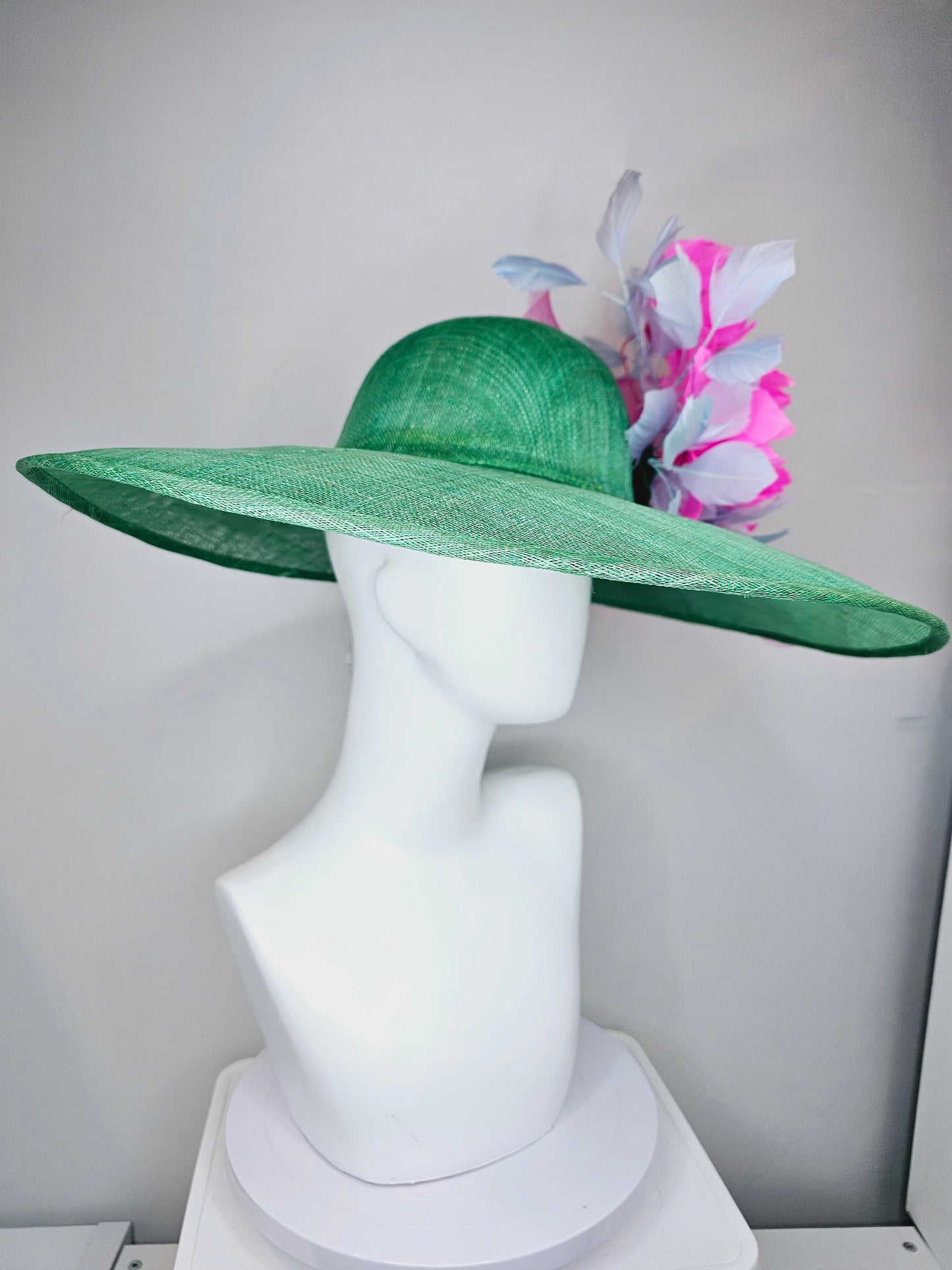 kentucky derby hat large wide brim sinamay emerald green hat with fuchsia pink feather flower and lavender feathers with pink crinoline