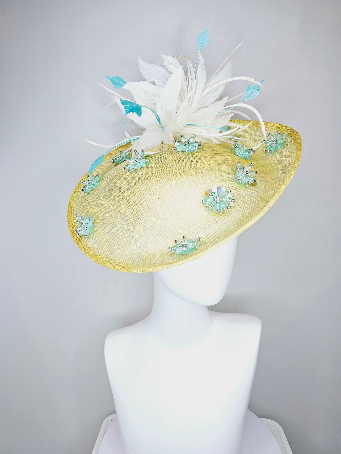 kentucky derby hat fascinator yellow sinamay saucer with white and blue feathers with blue crystal jewel beaded flowers