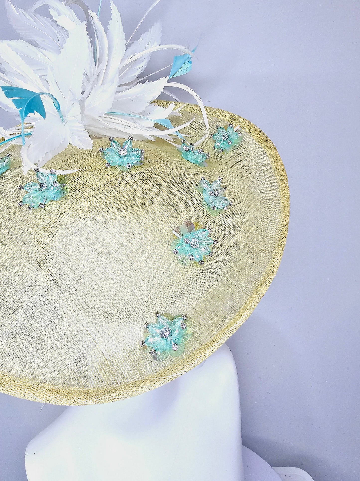 kentucky derby hat fascinator yellow sinamay saucer with white and blue feathers with blue crystal jewel beaded flowers