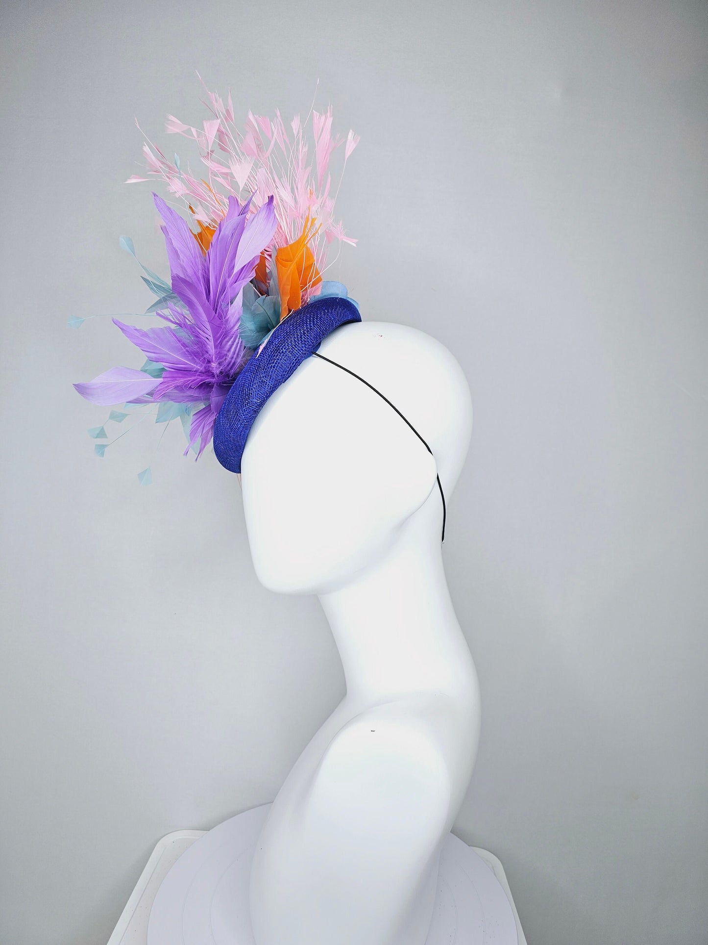 kentucky derby hat fascinator royal blue sinamay with violet purple, teal blue, apricot orange yellow, and baby pink branching feathers