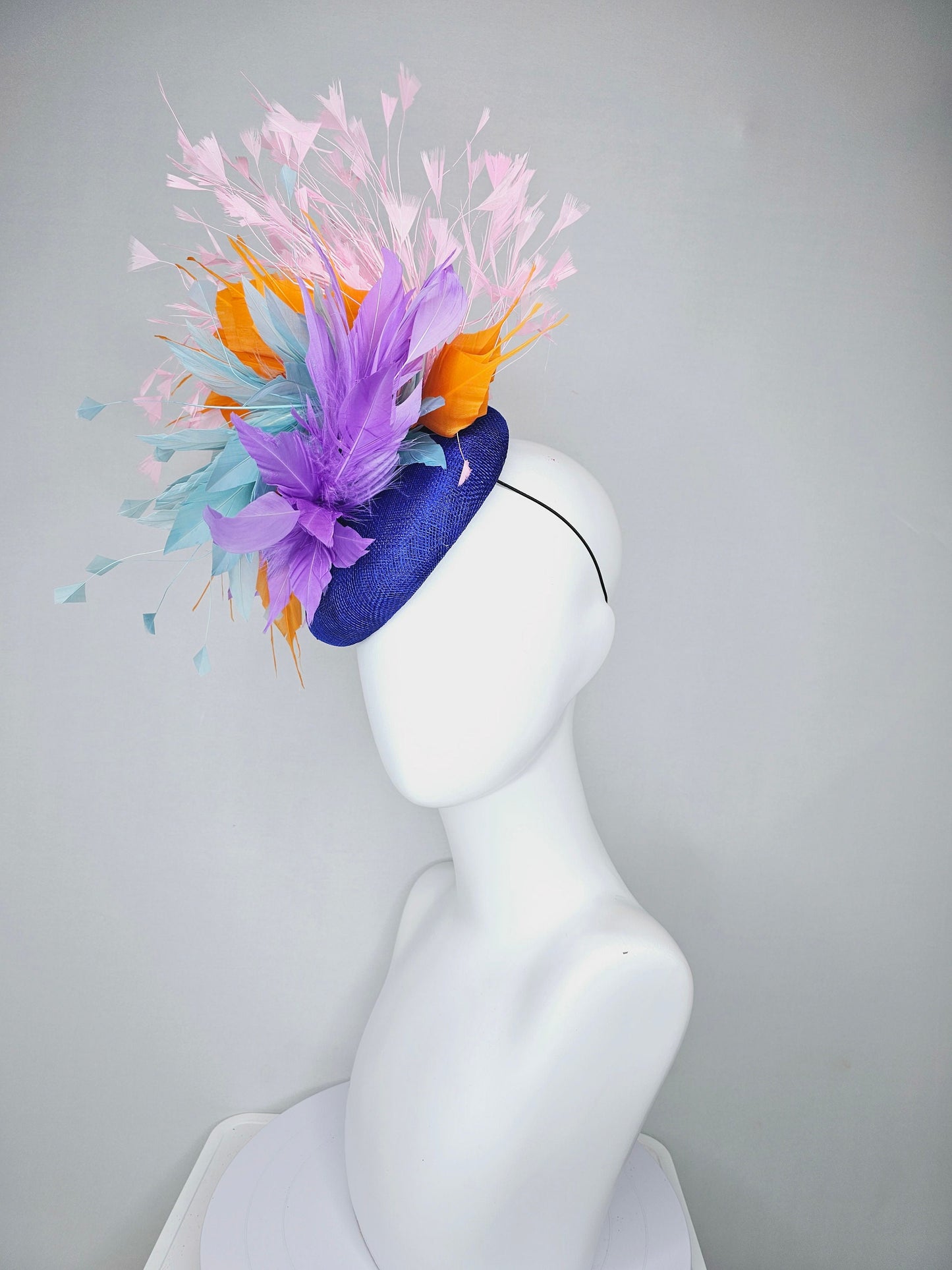 kentucky derby hat fascinator royal blue sinamay with violet purple, teal blue, apricot orange yellow, and baby pink branching feathers