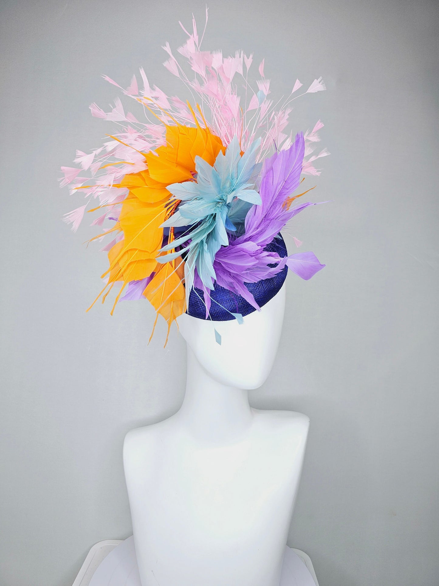 kentucky derby hat fascinator royal blue sinamay with violet purple, teal blue, apricot orange yellow, and baby pink branching feathers