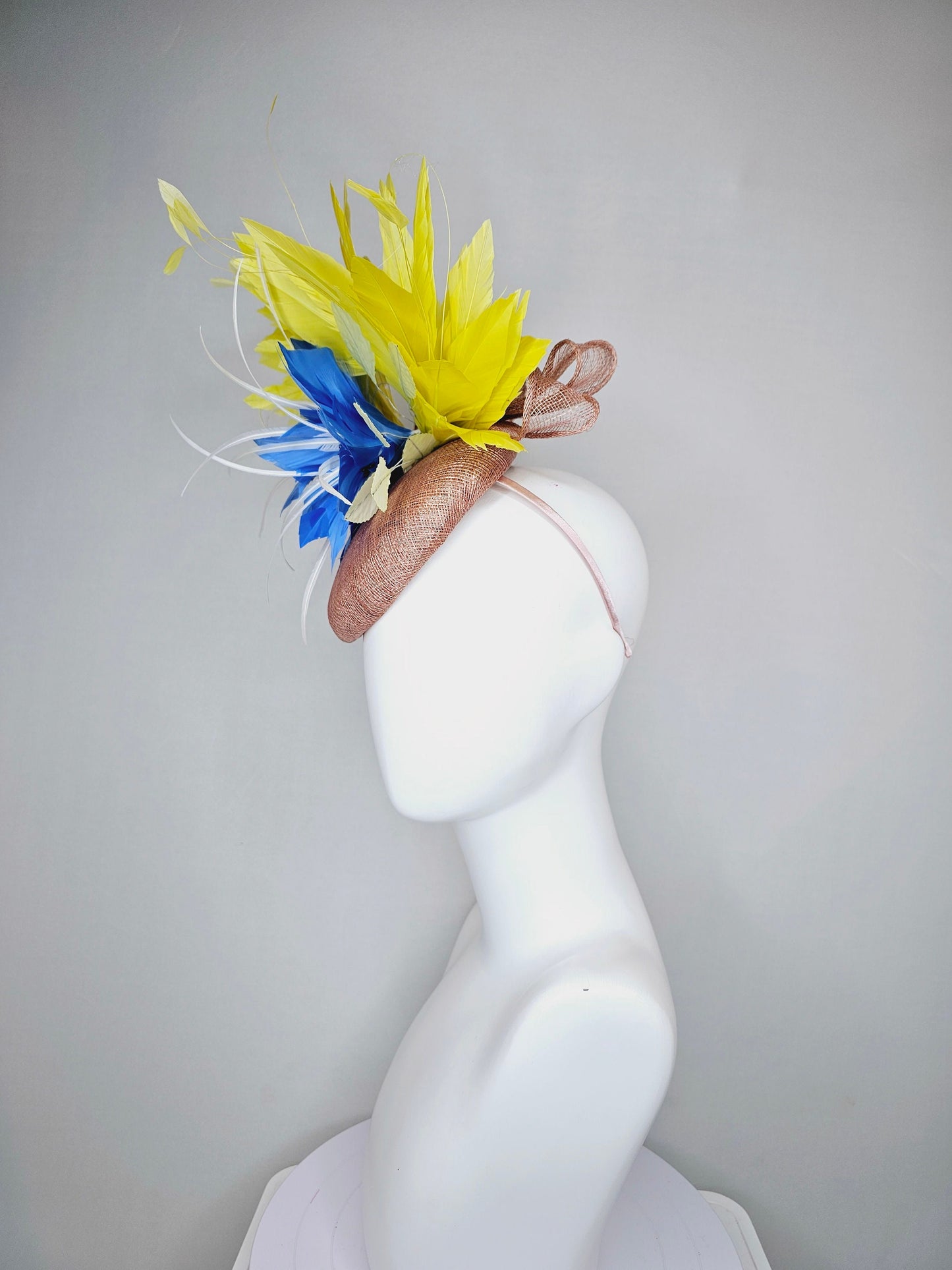 kentucky derby hat fascinator taupe neutral brown sinamay with bright yellow feathers and large blue feather flowers with white feathers