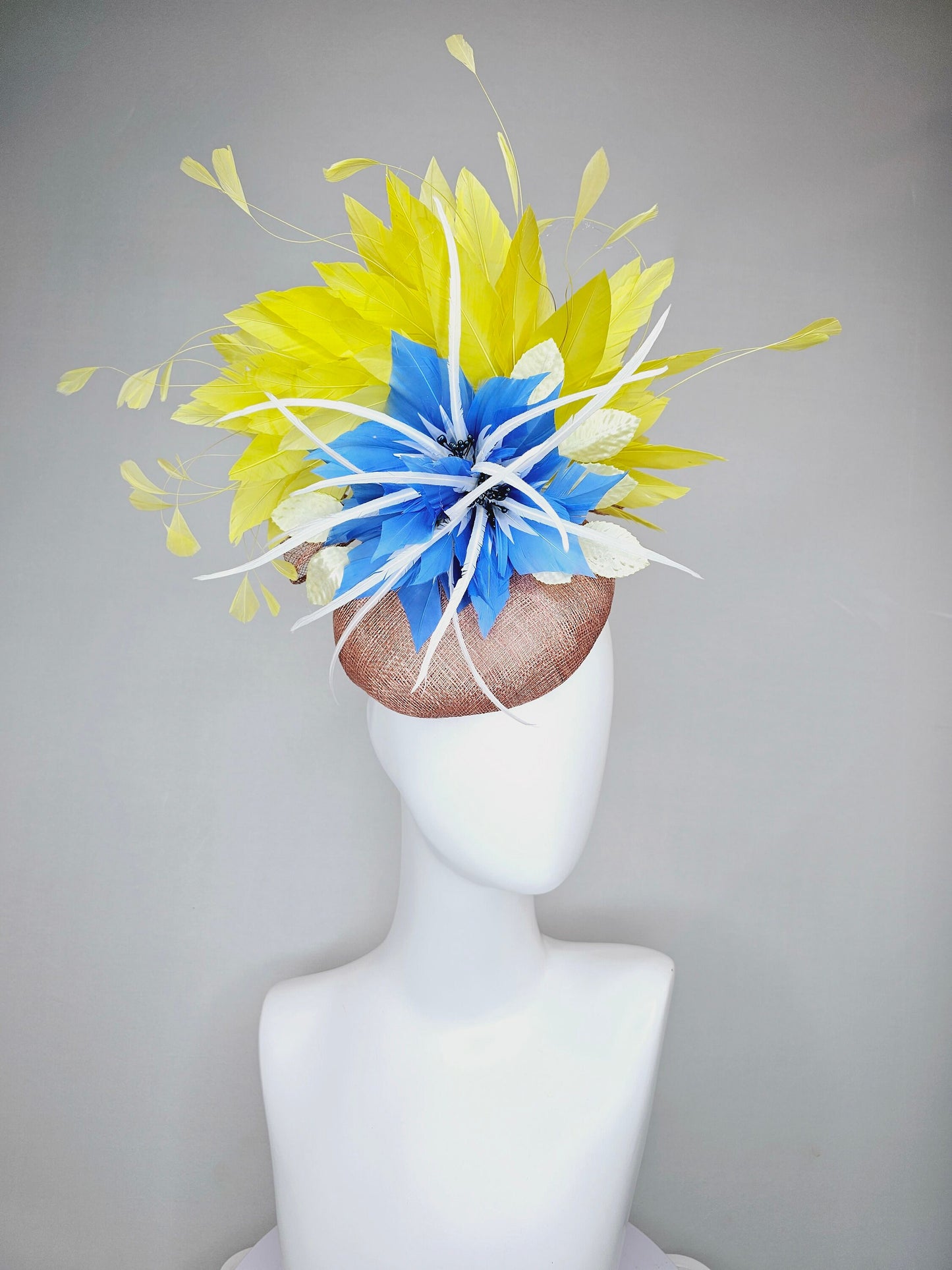 kentucky derby hat fascinator taupe neutral brown sinamay with bright yellow feathers and large blue feather flowers with white feathers