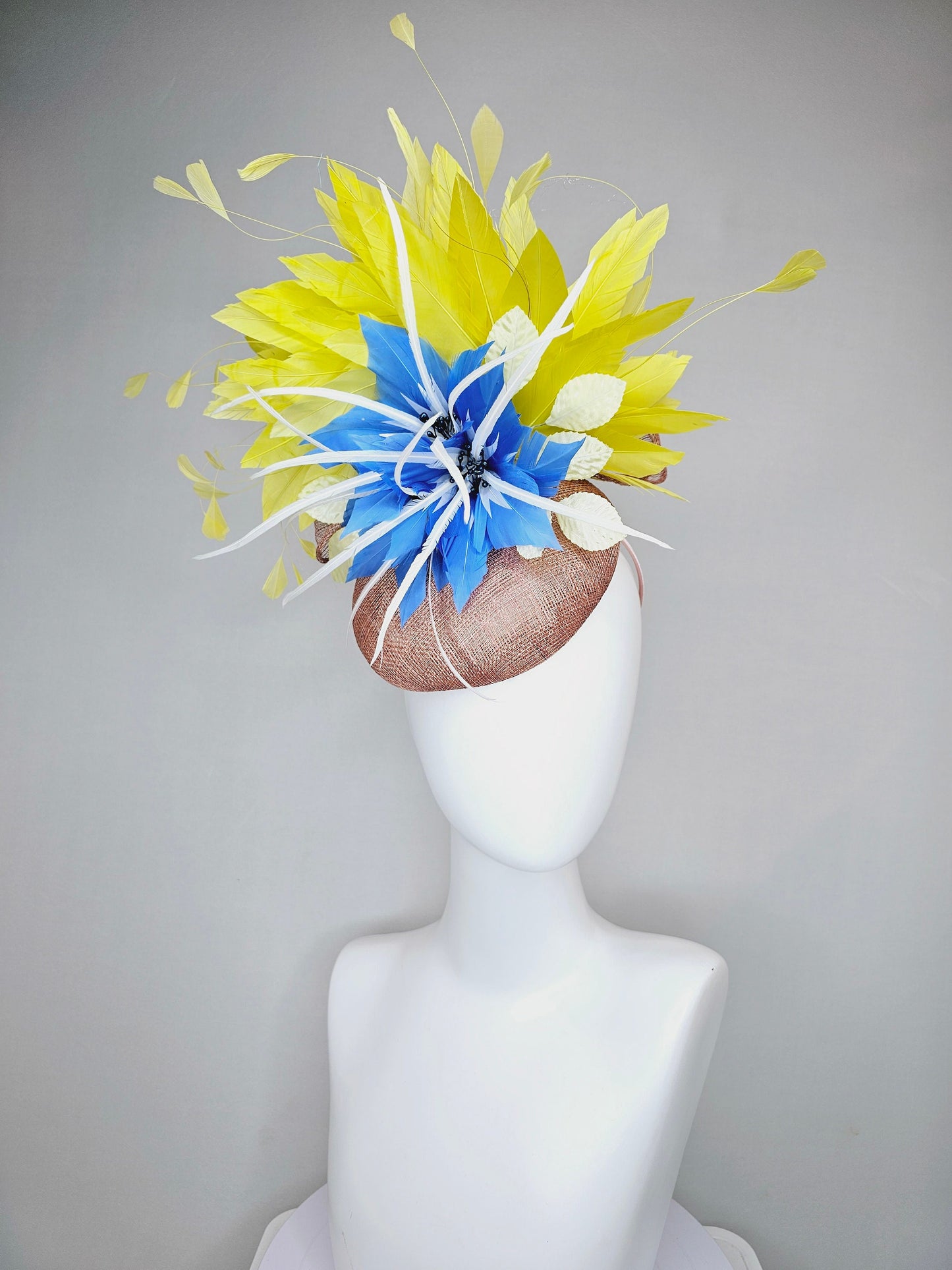 kentucky derby hat fascinator taupe neutral brown sinamay with bright yellow feathers and large blue feather flowers with white feathers