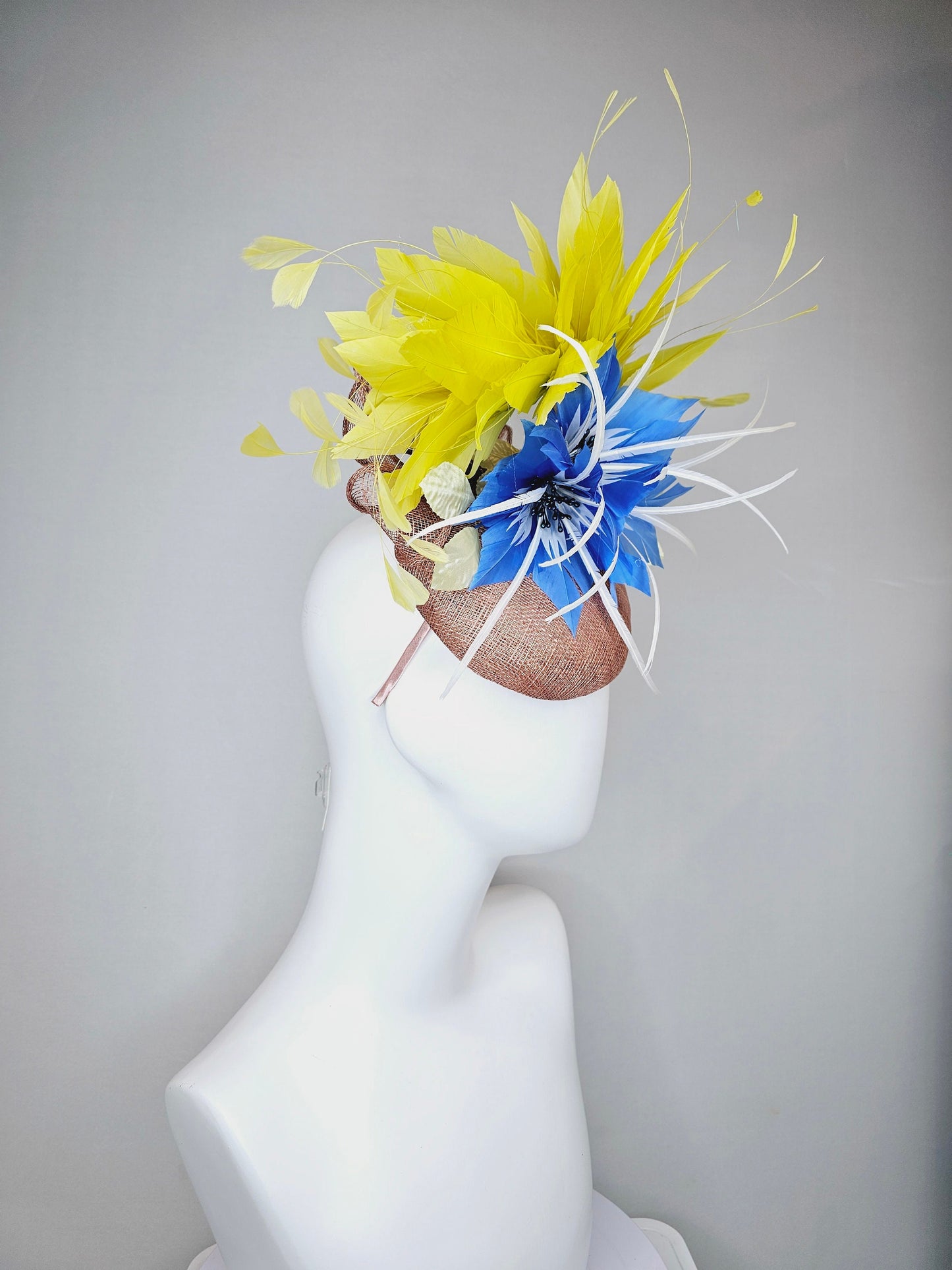 kentucky derby hat fascinator taupe neutral brown sinamay with bright yellow feathers and large blue feather flowers with white feathers