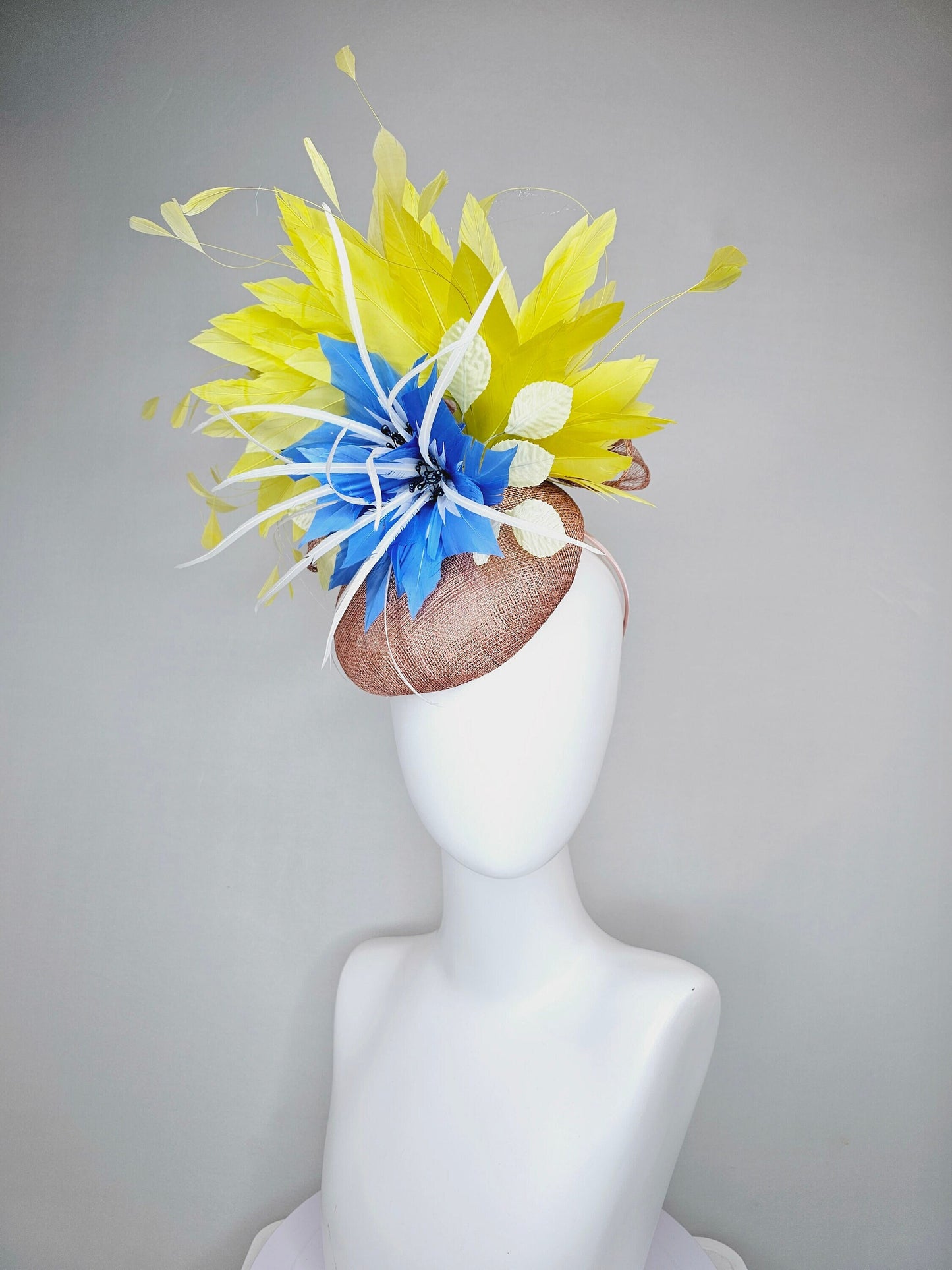 kentucky derby hat fascinator taupe neutral brown sinamay with bright yellow feathers and large blue feather flowers with white feathers