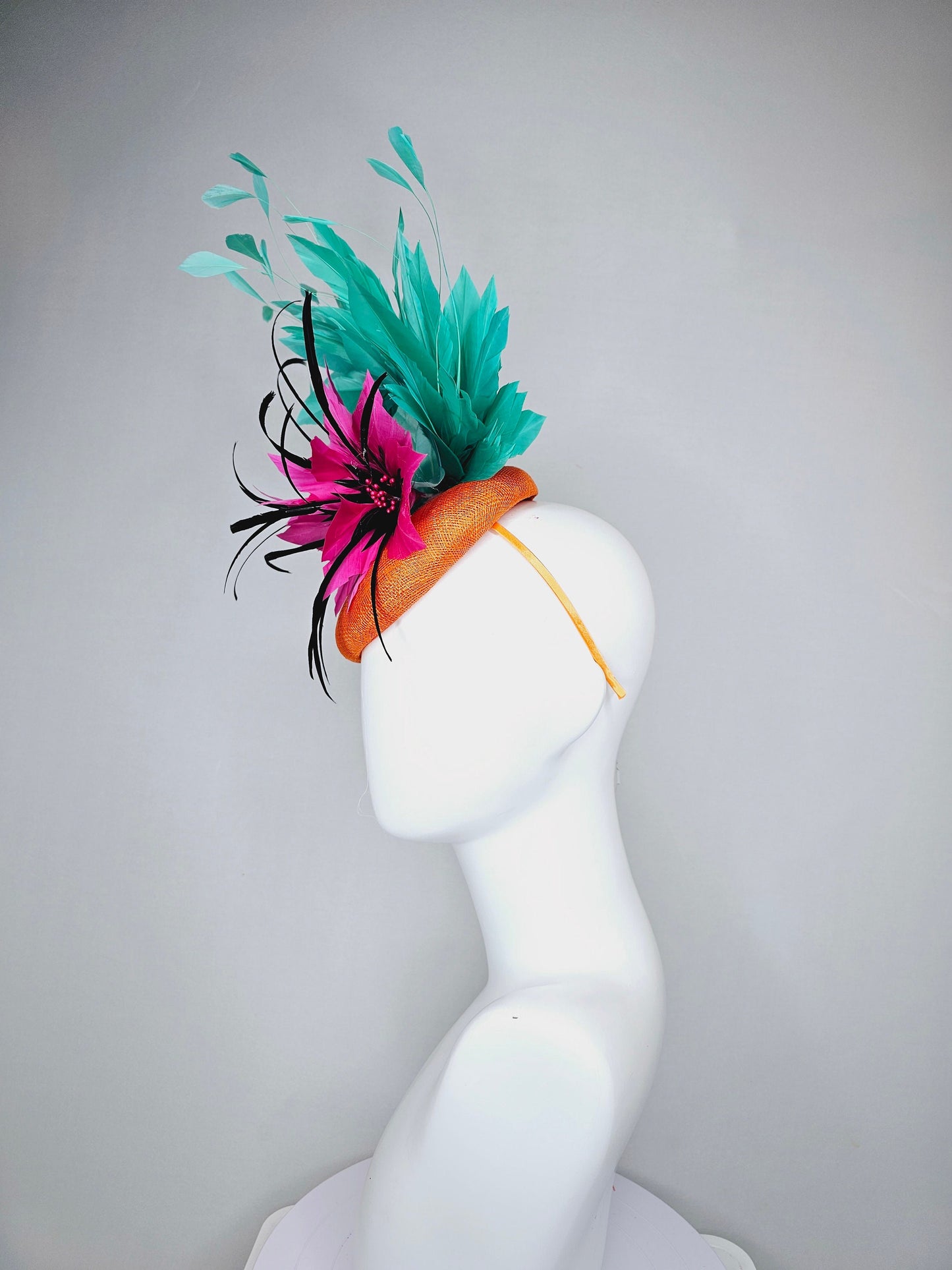 kentucky derby hat fascinator orange sinamay with large hot pink and black feather flowers and turquoise blue branching feathers