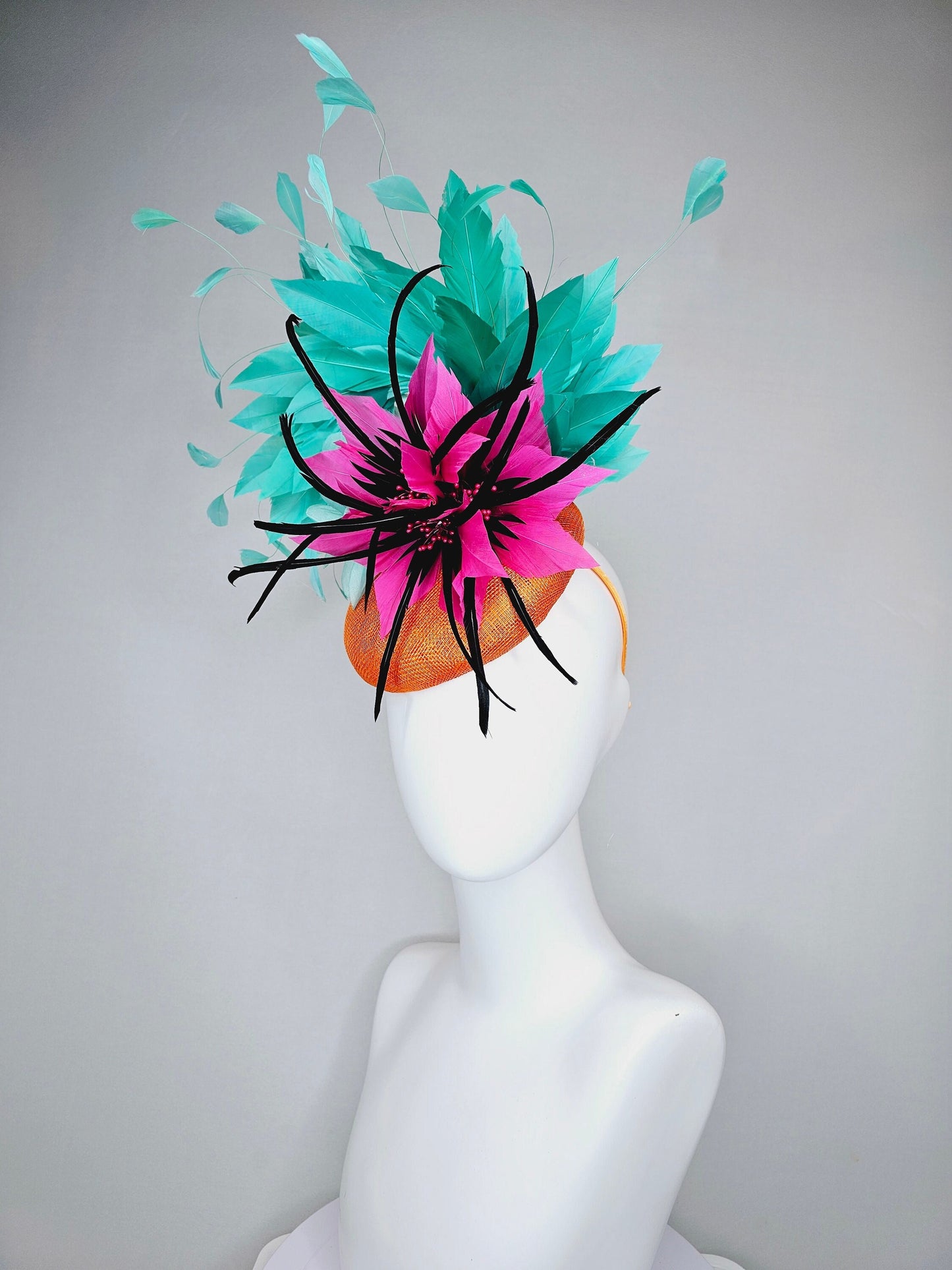 kentucky derby hat fascinator orange sinamay with large hot pink and black feather flowers and turquoise blue branching feathers