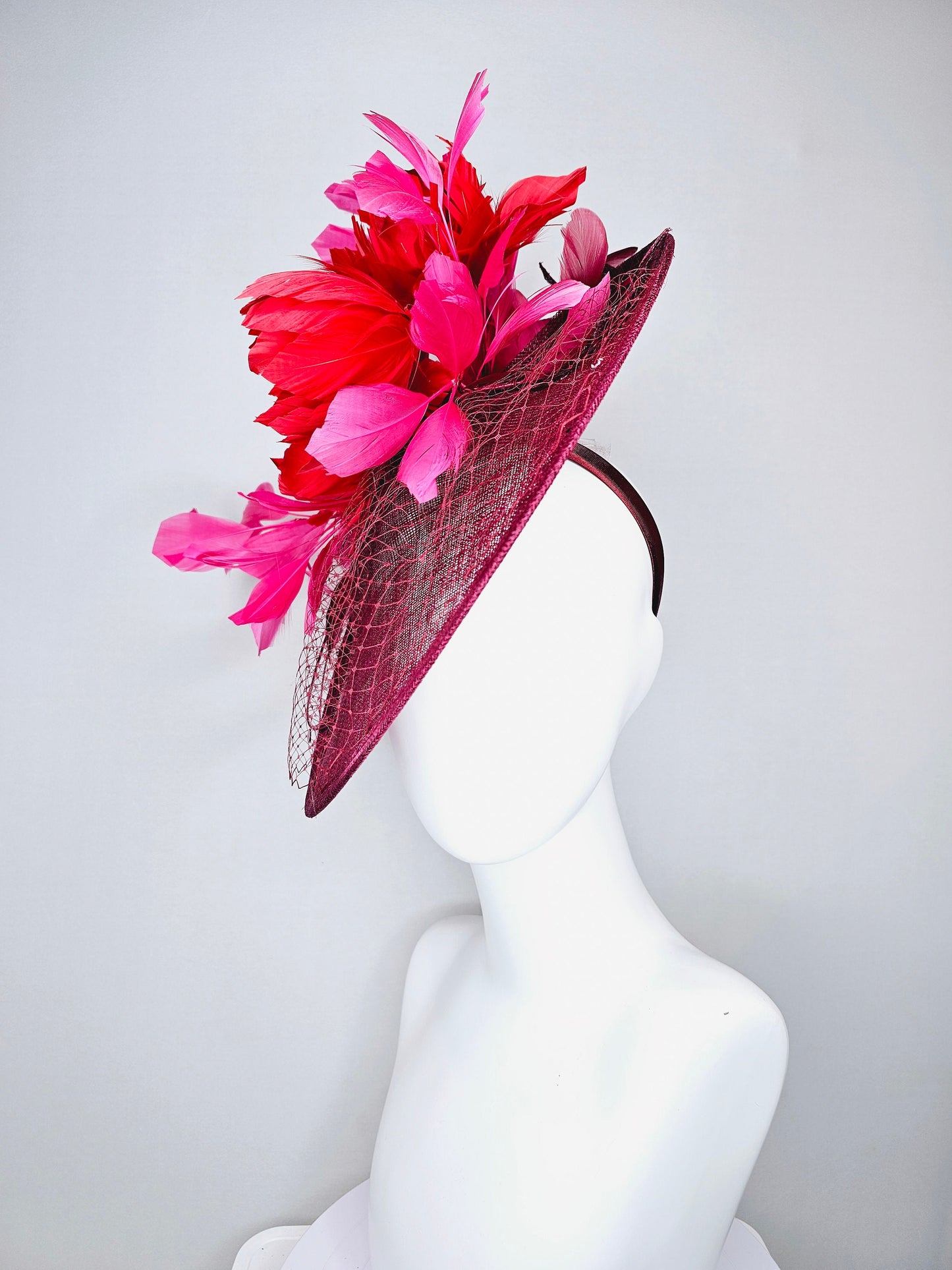 kentucky derby hat fascinator burgundy wine sinamay saucer with matching netting with sequin and red flower feather and hot pink feathers