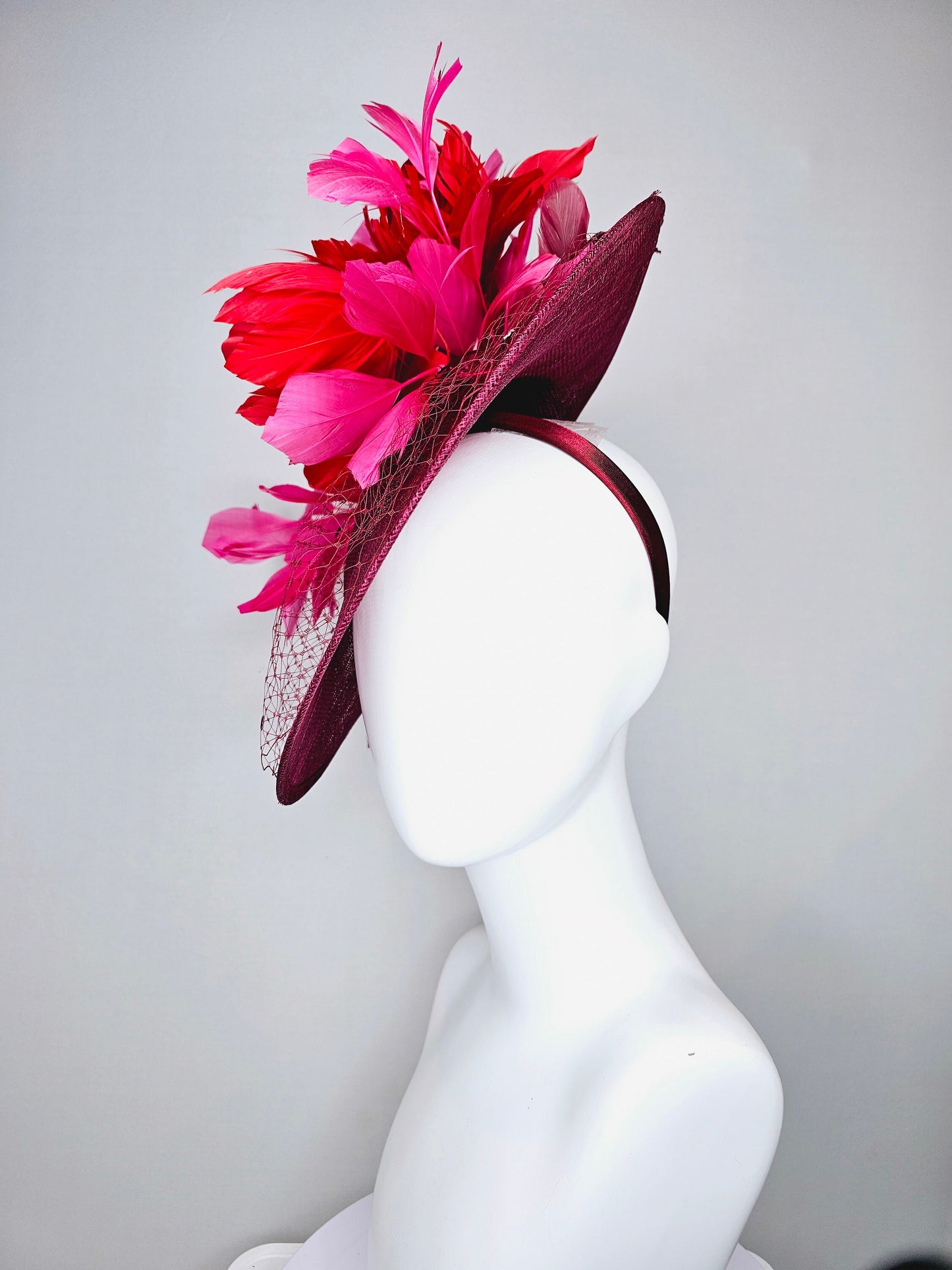 kentucky derby hat fascinator burgundy wine sinamay saucer with matching netting with sequin and red flower feather and hot pink feathers