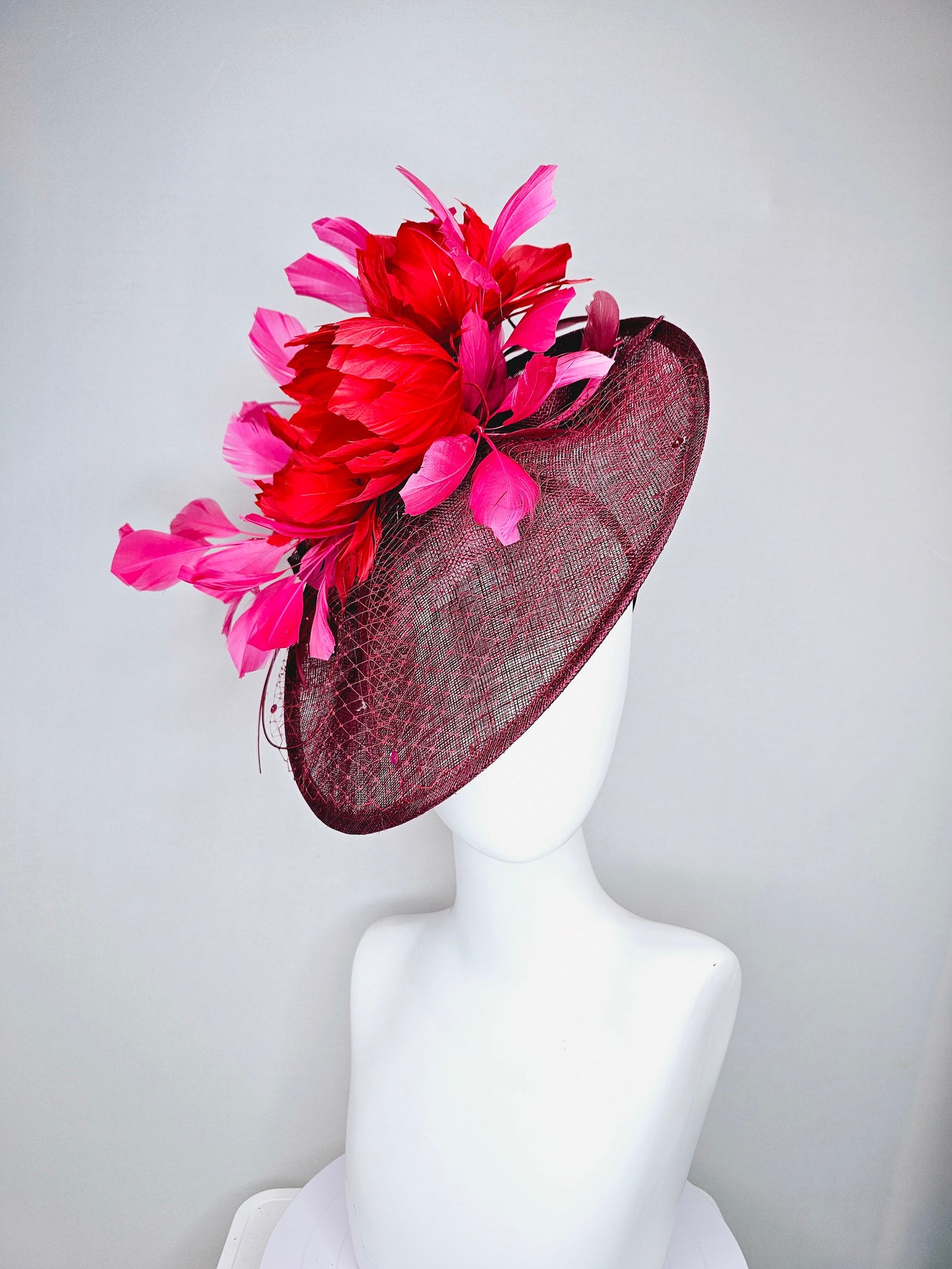 kentucky derby hat fascinator burgundy wine sinamay saucer with matching netting with sequin and red flower feather and hot pink feathers