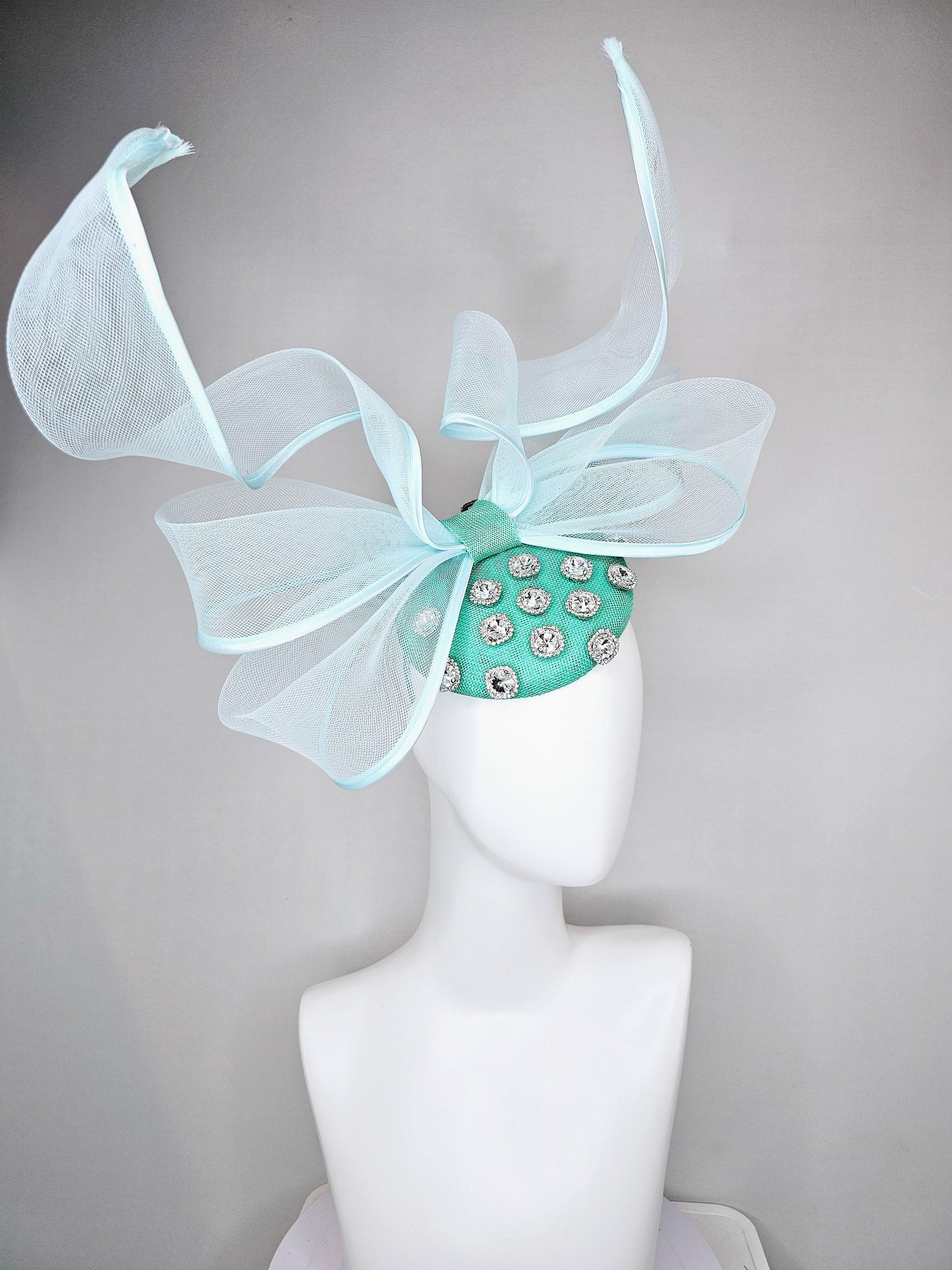 kentucky derby hat fascinator mint green fabric base with mesh and wired ribbon large bendable bow decor with clear  crystal jewels