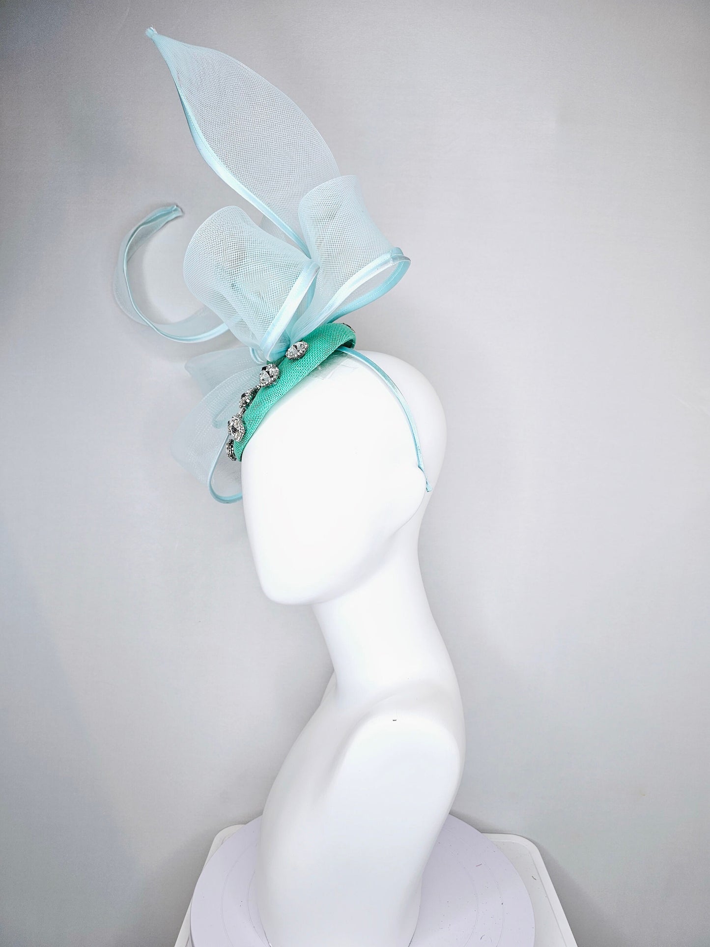 kentucky derby hat fascinator mint green fabric base with mesh and wired ribbon large bendable bow decor with clear  crystal jewels