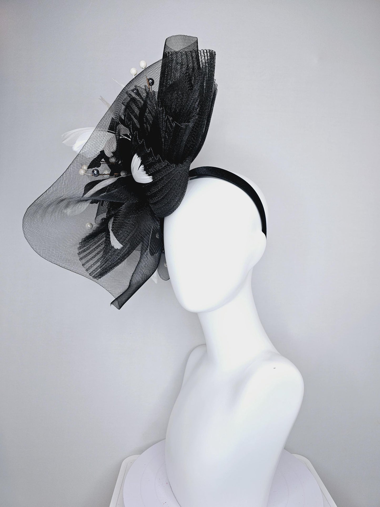 kentucky derby hat fascinator black pleated crinoline pouf with white and black feathers and branching white, sparkly, silver pearls