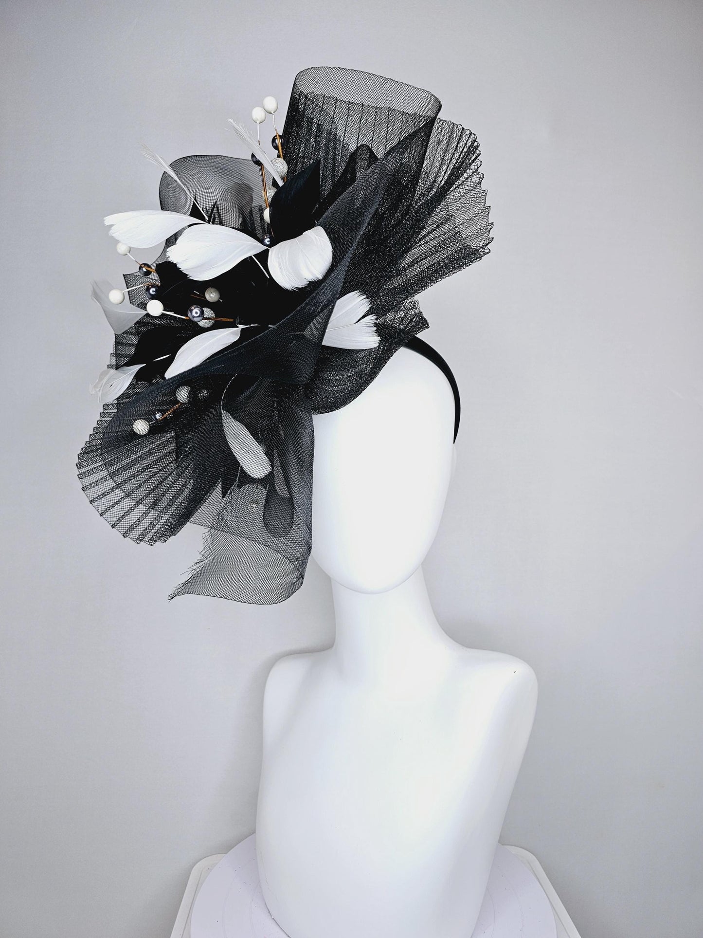 kentucky derby hat fascinator black pleated crinoline pouf with white and black feathers and branching white, sparkly, silver pearls