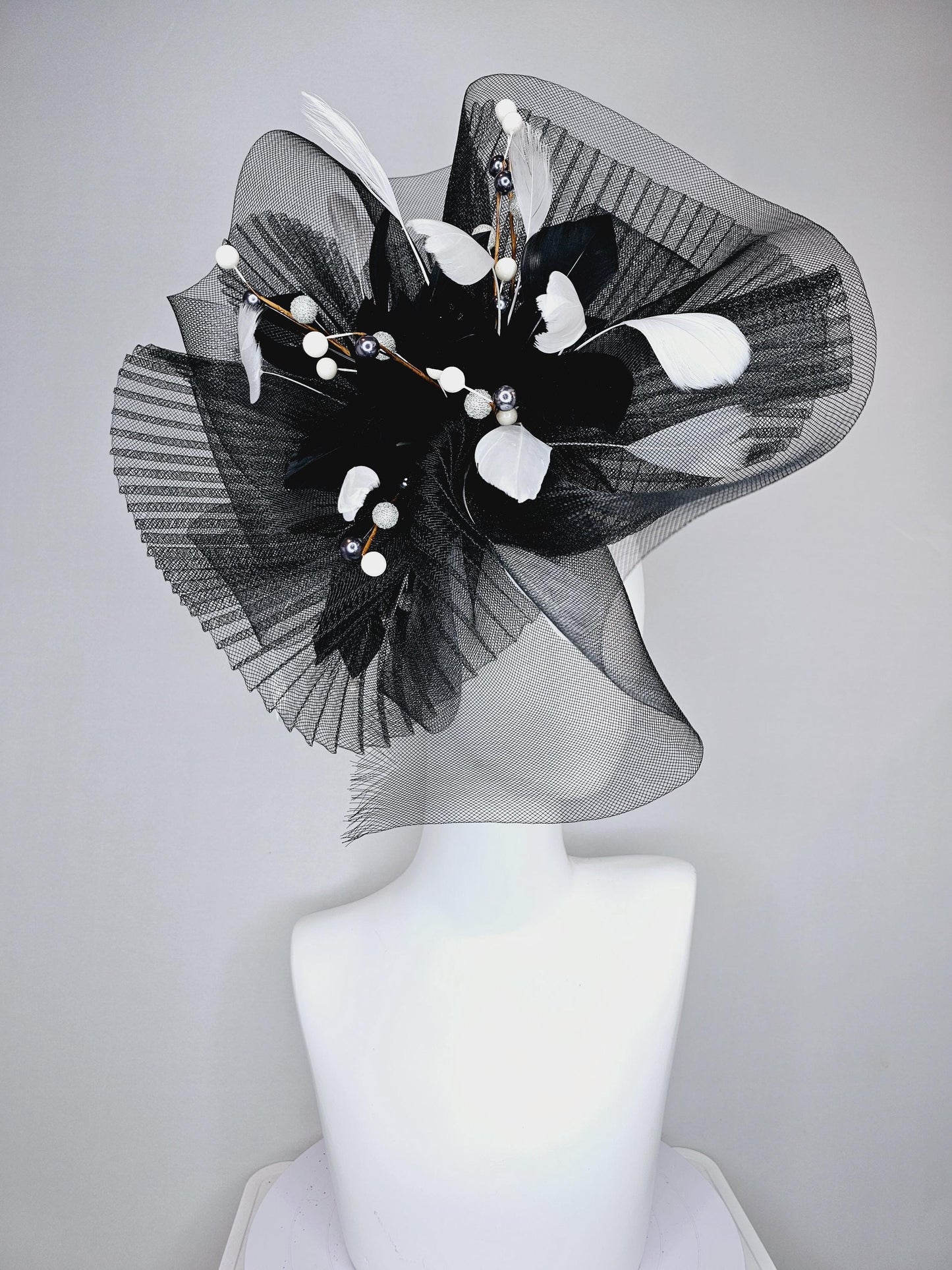 kentucky derby hat fascinator black pleated crinoline pouf with white and black feathers and branching white, sparkly, silver pearls