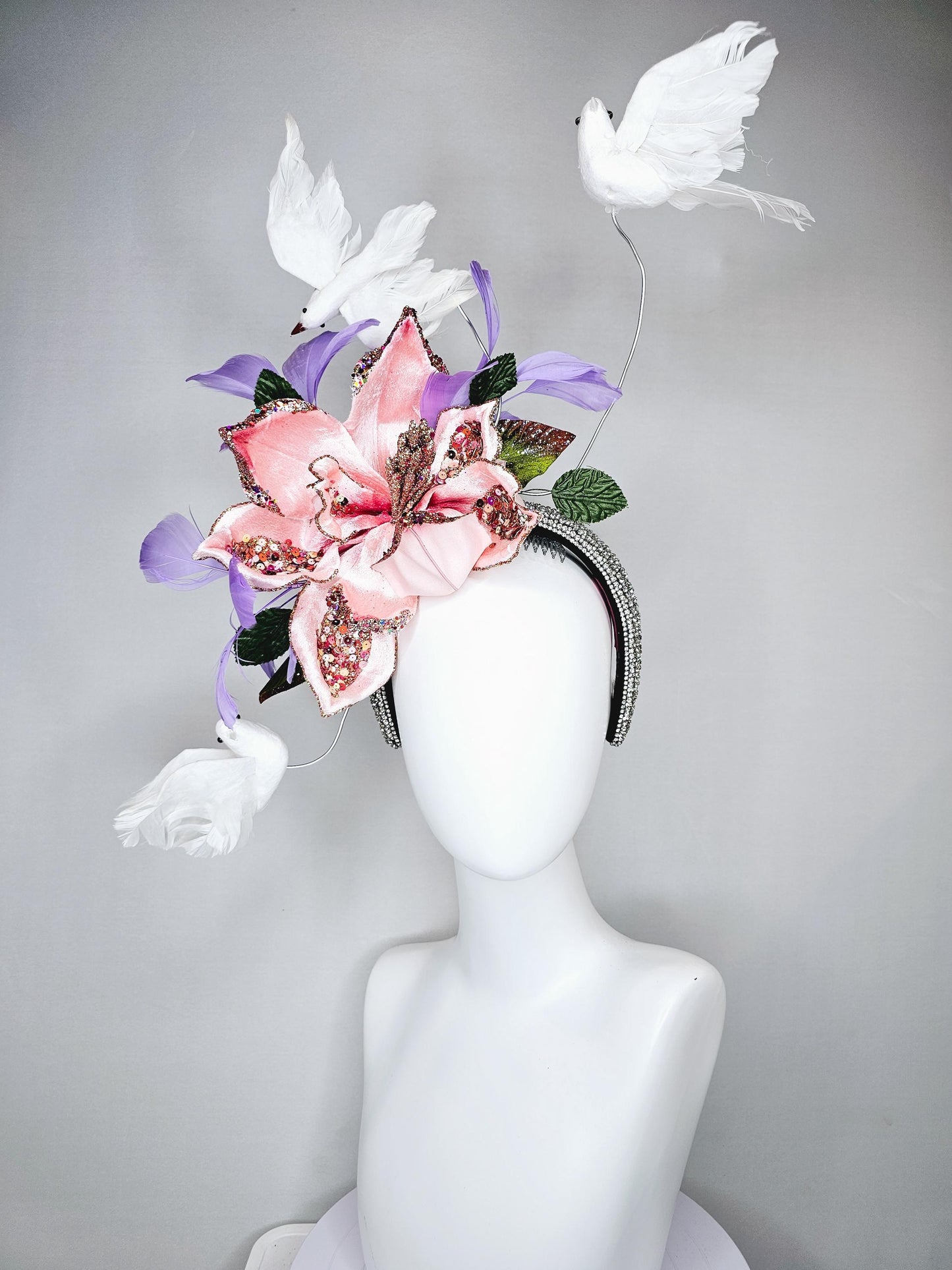 kentucky derby hat fascinator crystal rhinestone headband with light pink sparkle flower, purple lavender feathers and white feather birds