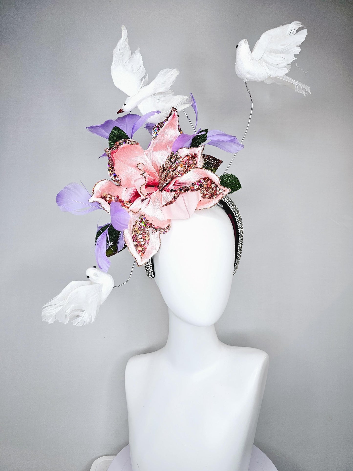 kentucky derby hat fascinator crystal rhinestone headband with light pink sparkle flower, purple lavender feathers and white feather birds