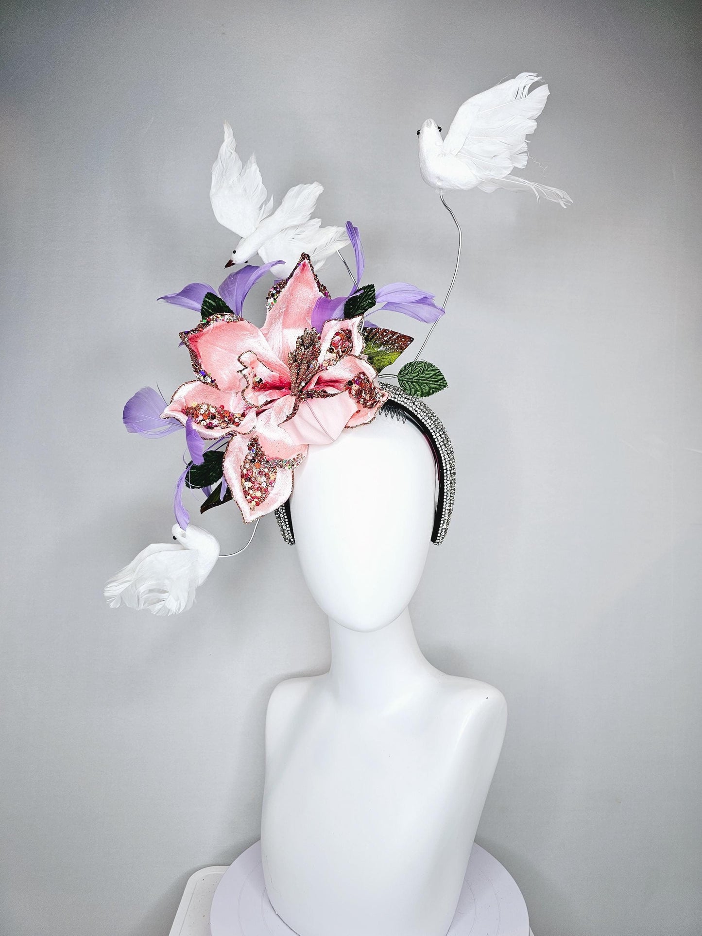 kentucky derby hat fascinator crystal rhinestone headband with light pink sparkle flower, purple lavender feathers and white feather birds