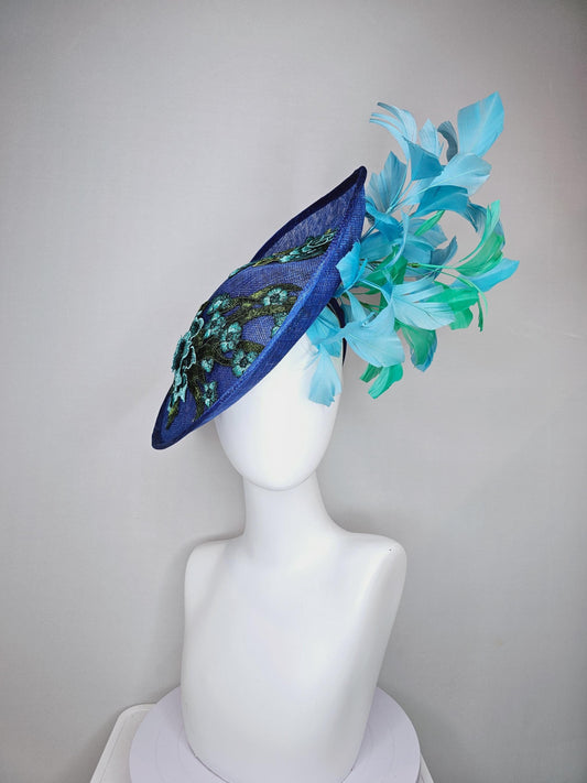 kentucky derby hat fascinator royal blue sinamay saucer with light blue and green feathers and green blue teal embroidered flowers