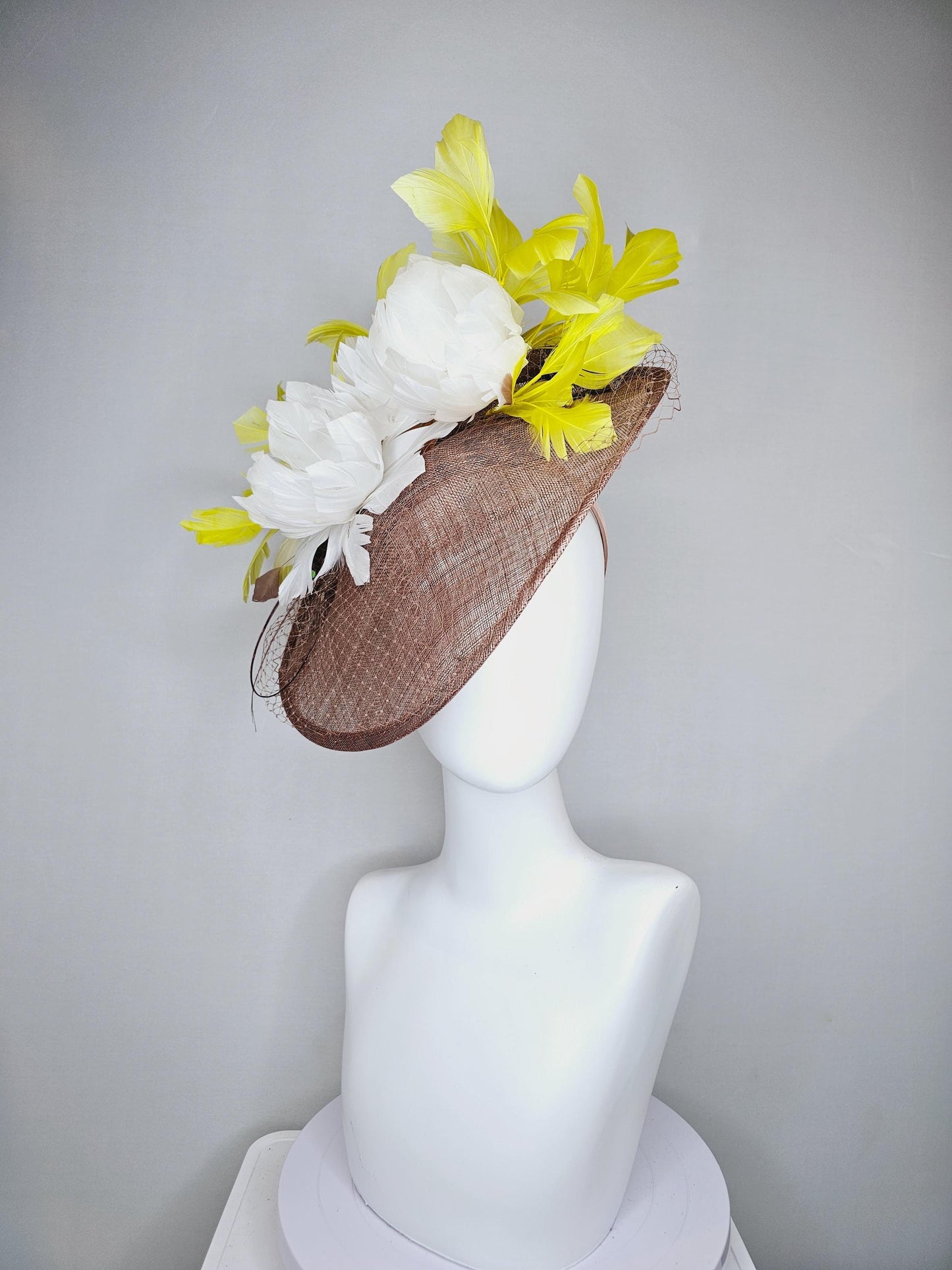 kentucky derby hat fascinator taupe brown sinamay saucer with netting, white fluffy feather flowers and yellow branching feathers