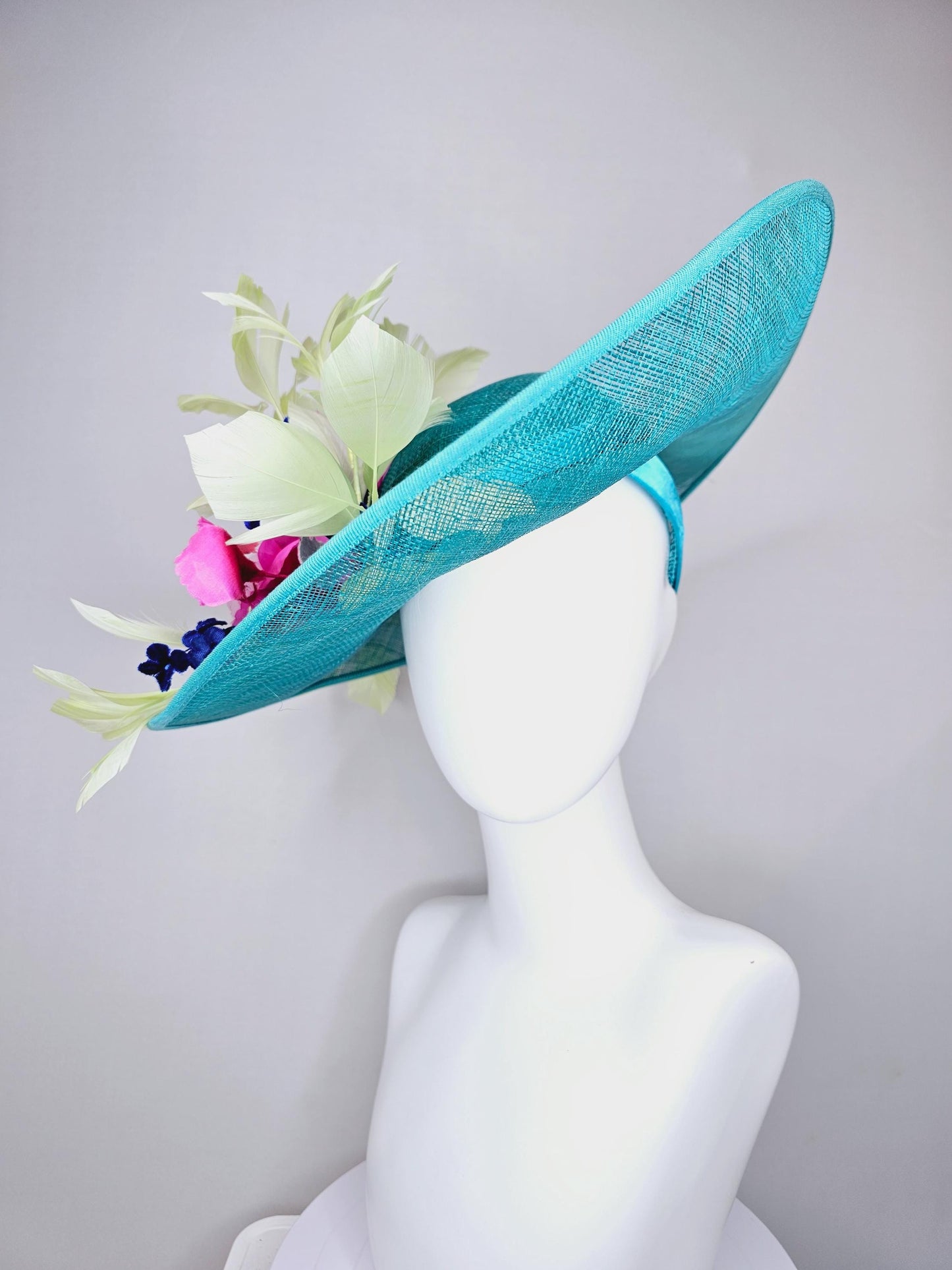 kentucky derby hat large wide brim sinamay turquoise blue hat hot pink silk flowers,mint green feathers,purple leaves navy blue flower stems