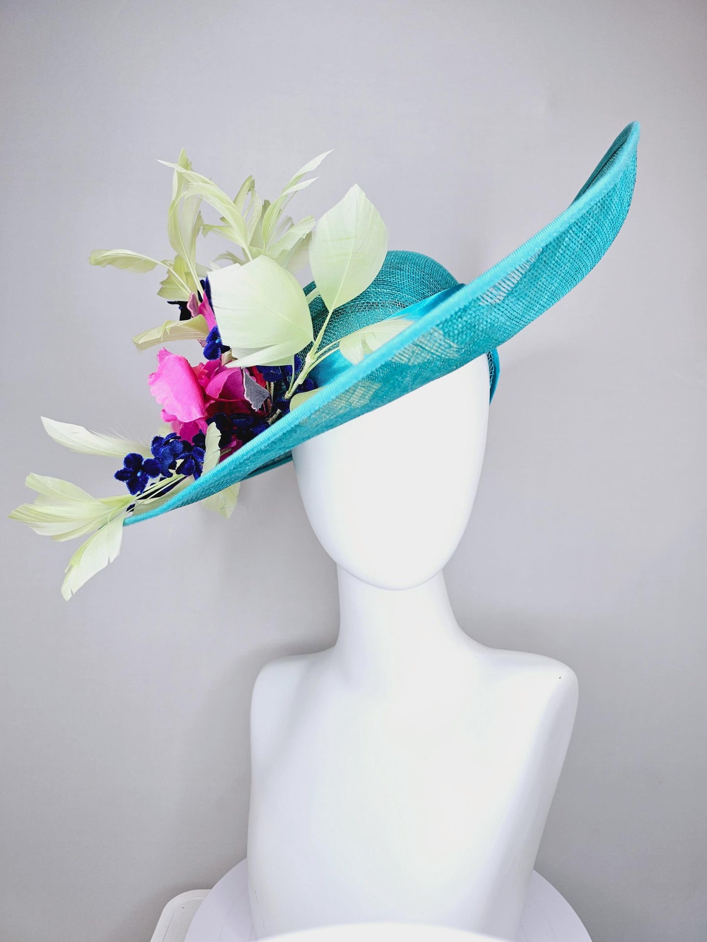 kentucky derby hat large wide brim sinamay turquoise blue hat hot pink silk flowers,mint green feathers,purple leaves navy blue flower stems