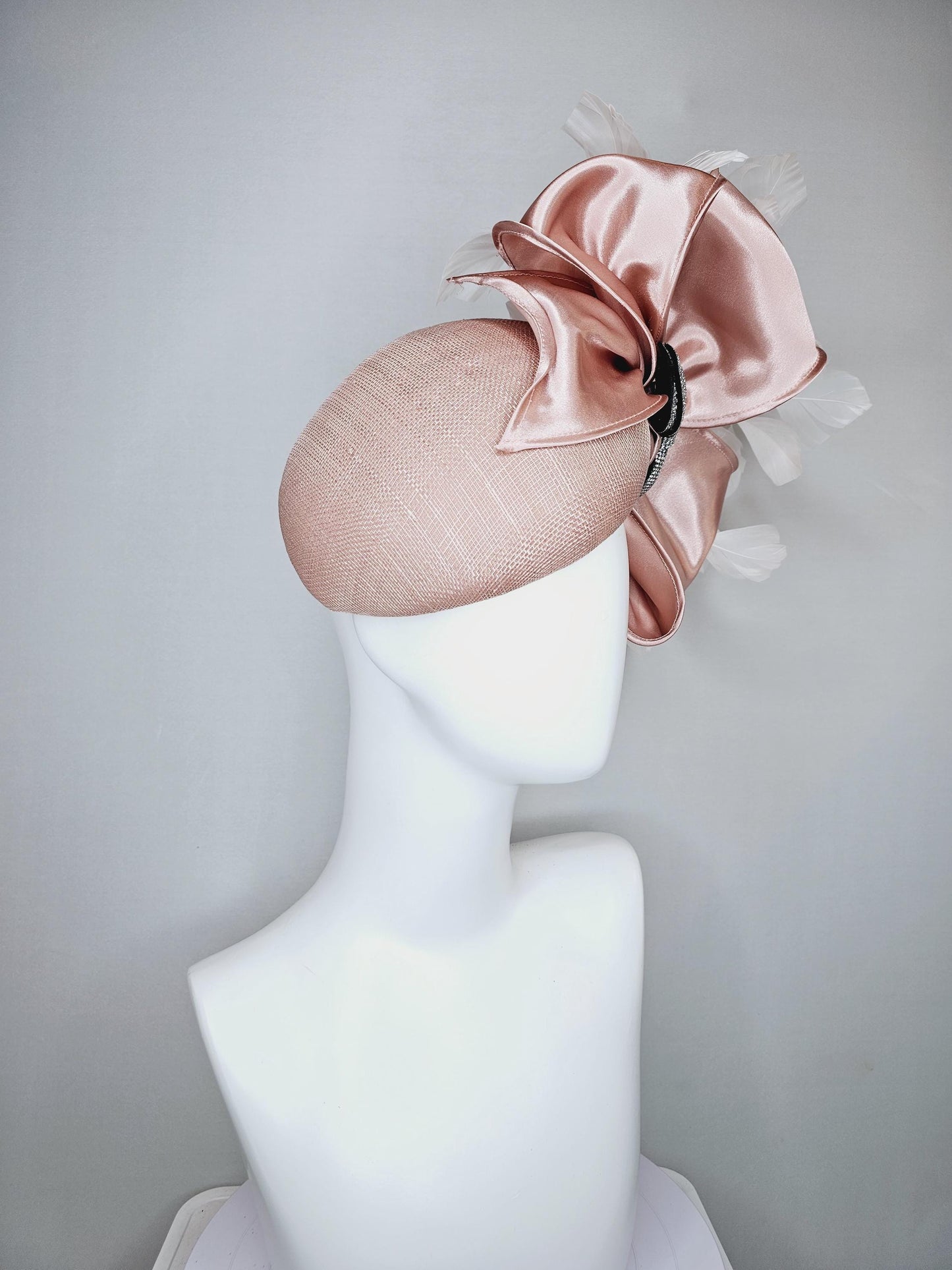 kentucky derby hat fascinator light dusty pink sinamay with satin champagne pink bow with Swarovski crystal bow and branching white feather