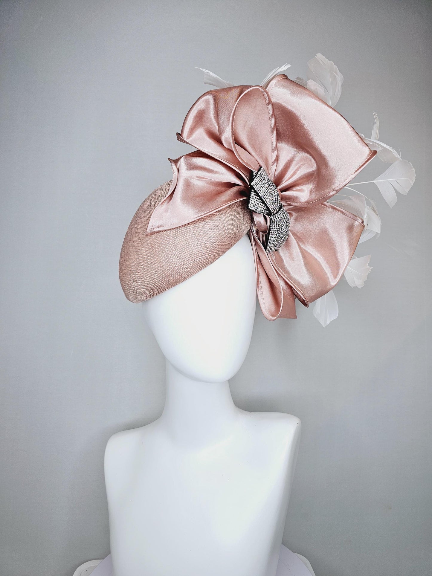 kentucky derby hat fascinator light dusty pink sinamay with satin champagne pink bow with Swarovski crystal bow and branching white feather