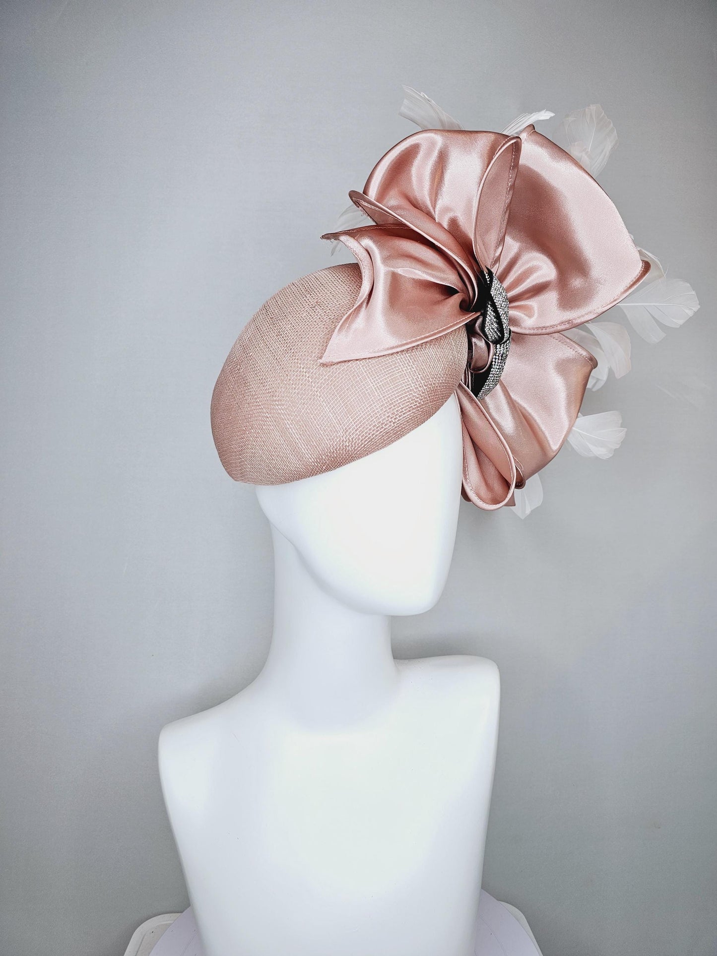 kentucky derby hat fascinator light dusty pink sinamay with satin champagne pink bow with Swarovski crystal bow and branching white feather