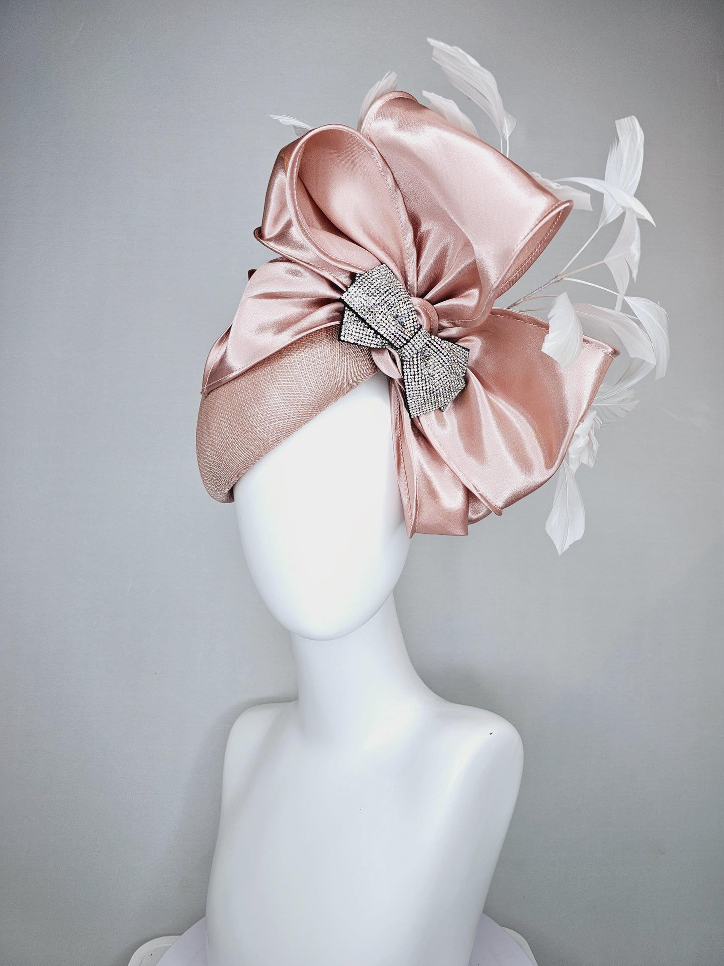 kentucky derby hat fascinator light dusty pink sinamay with satin champagne pink bow with Swarovski crystal bow and branching white feather