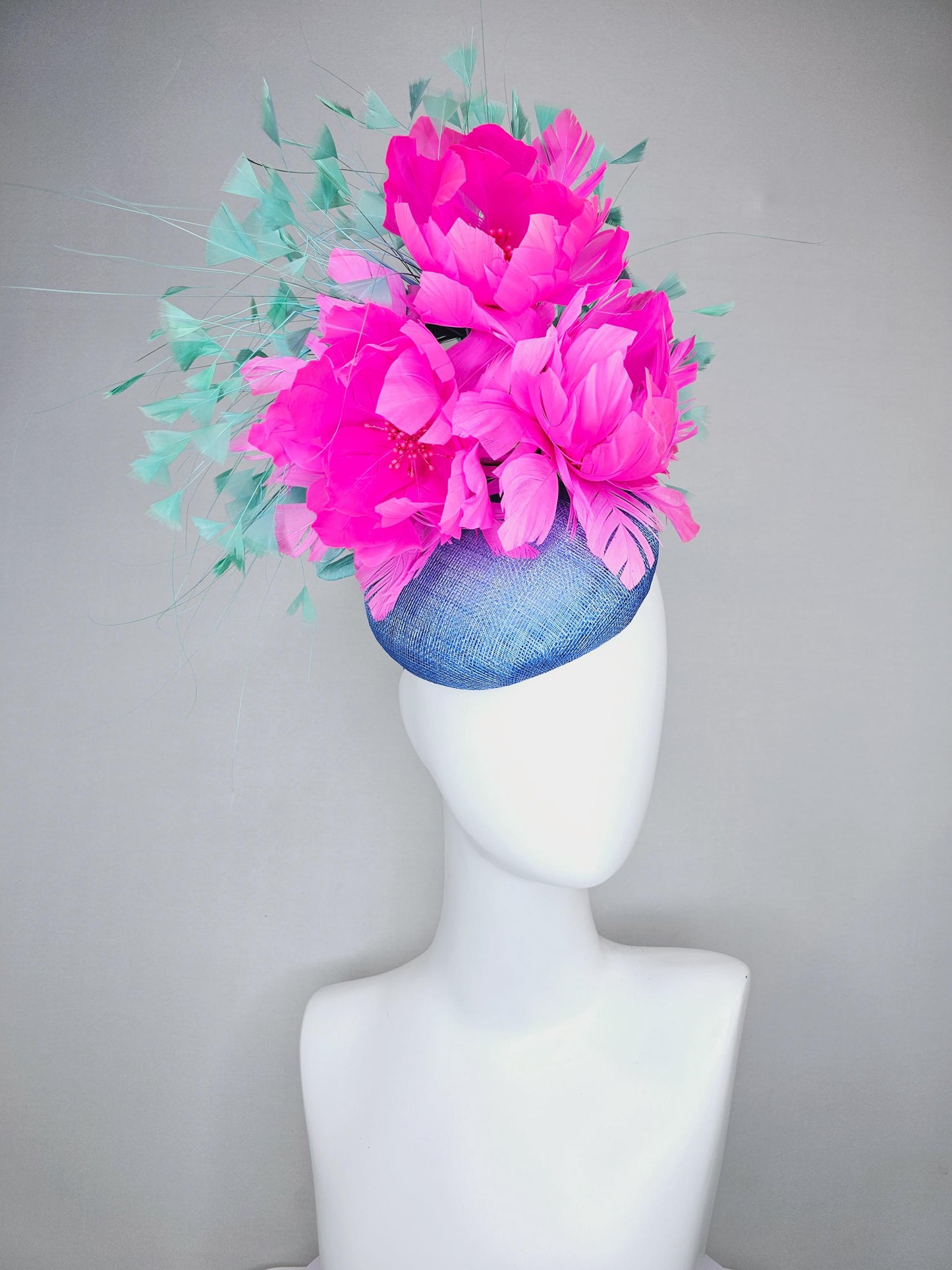 kentucky derby hat fascinator blue sinamay saucer with bright fuchsia hot pink feather flowers and mint green branching feathers