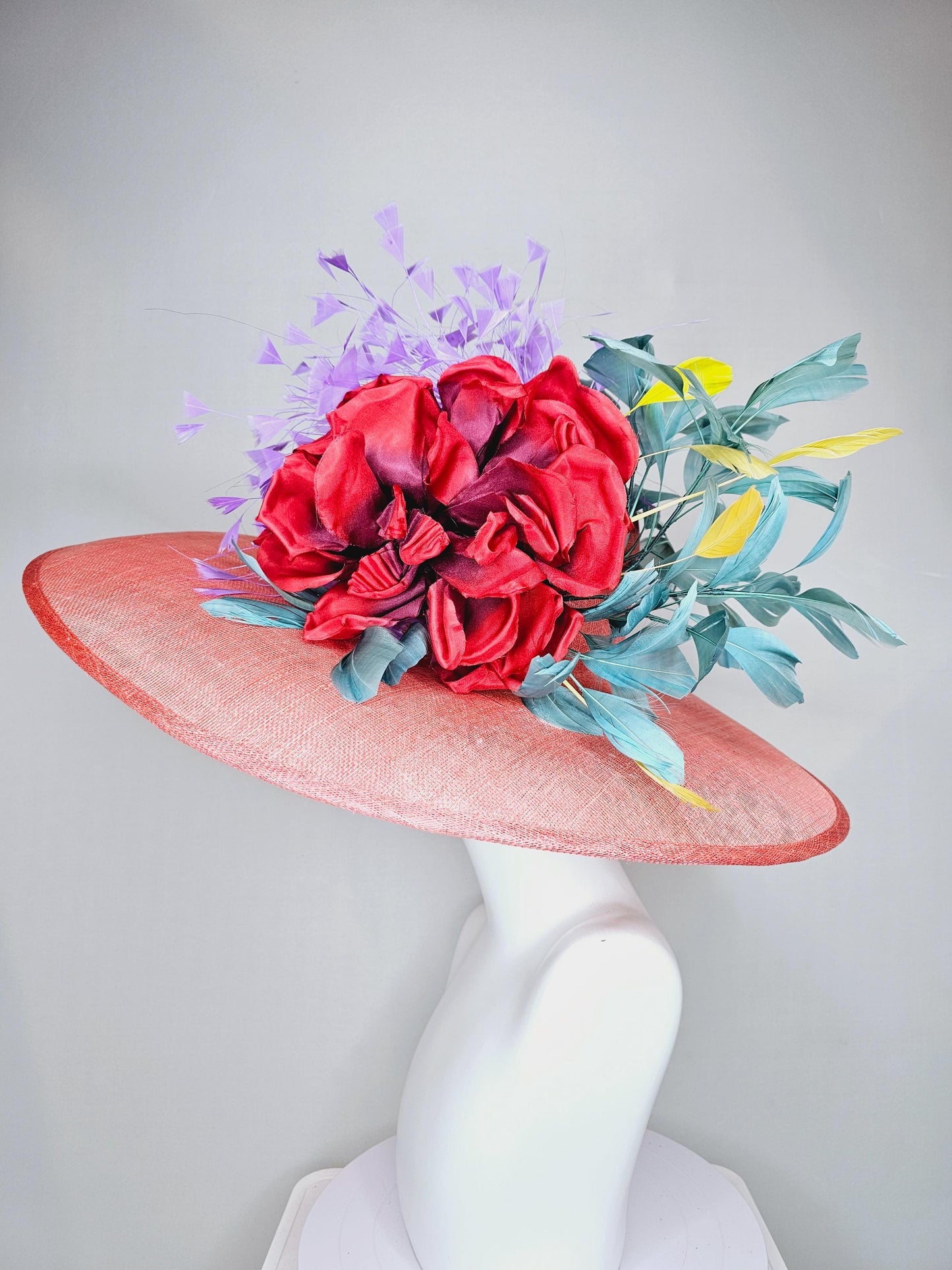 kentucky derby hat large wide brim sinamay coral orange hat with large red satin silk flower with purple,teal blue,yellow branching feathers