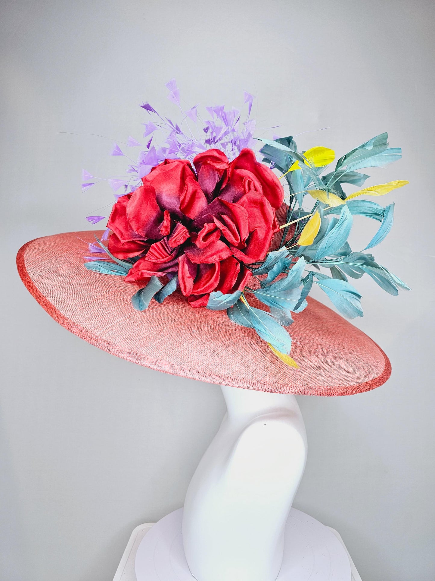 kentucky derby hat large wide brim sinamay coral orange hat with large red satin silk flower with purple,teal blue,yellow branching feathers