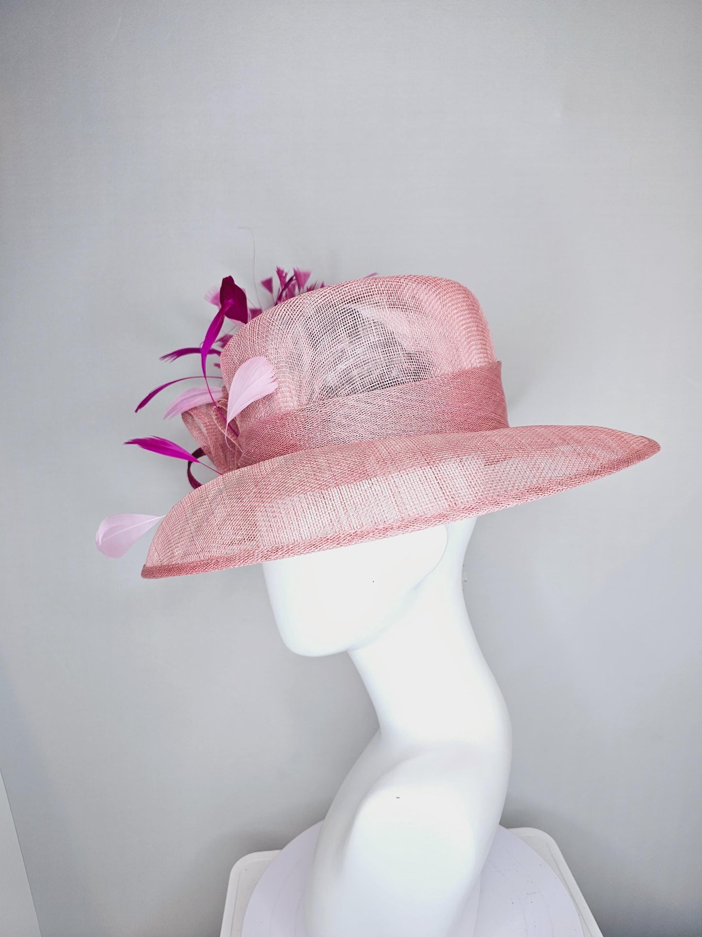 kentucky derby hat large wide brim sinamay light blush pink hat with fuchsia hot pink purple branching feathers and sinamay curls