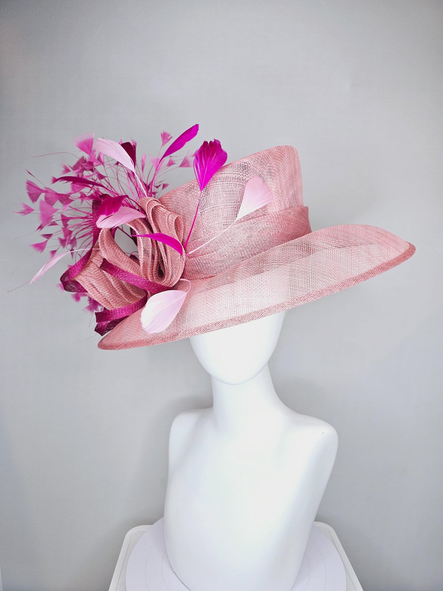 kentucky derby hat large wide brim sinamay light blush pink hat with fuchsia hot pink purple branching feathers and sinamay curls