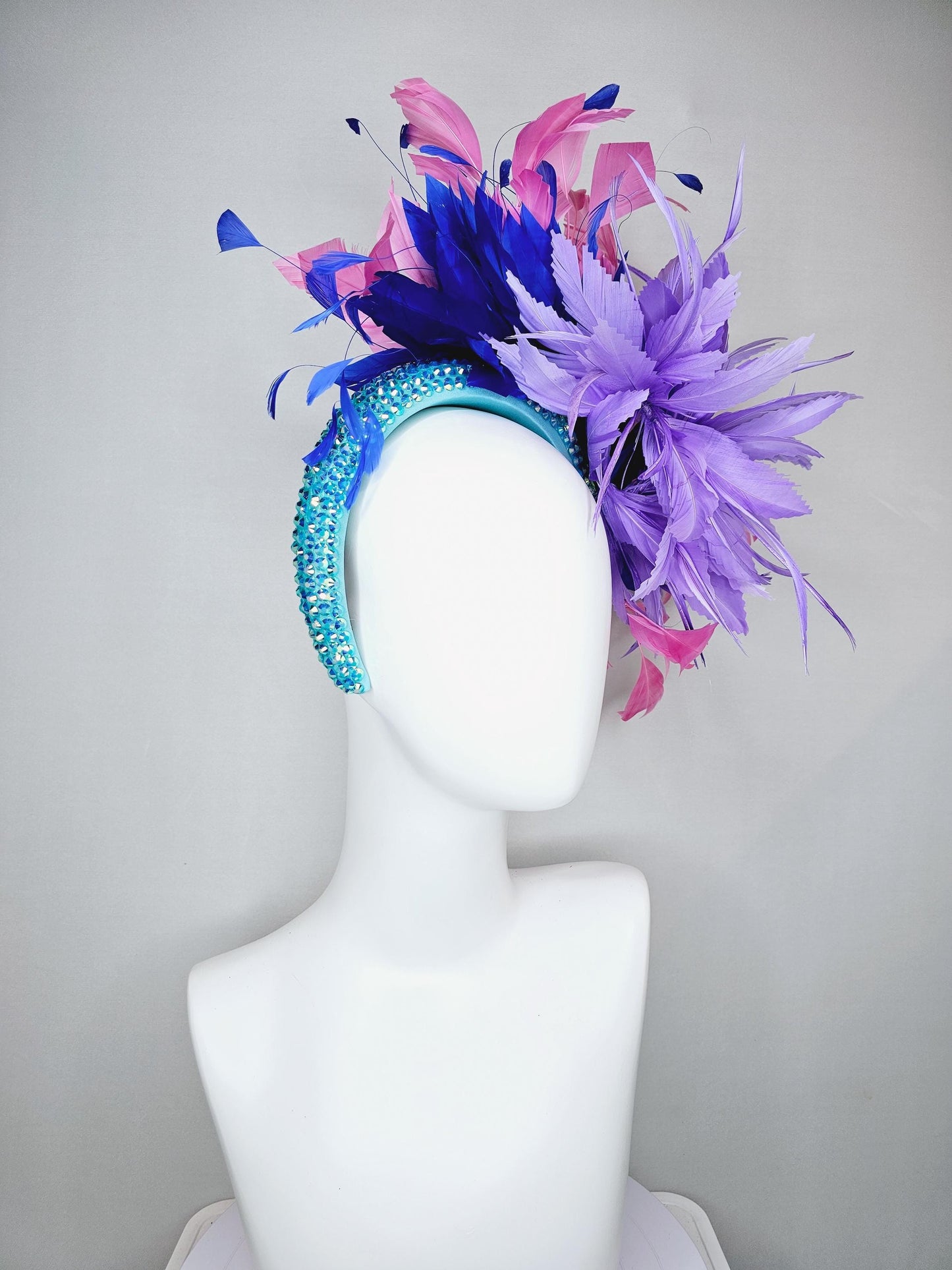 kentucky derby hat fascinator branching pink,royal blue,and purple lavender feathers on iridescent Swarovski crystal turquoise blue headband