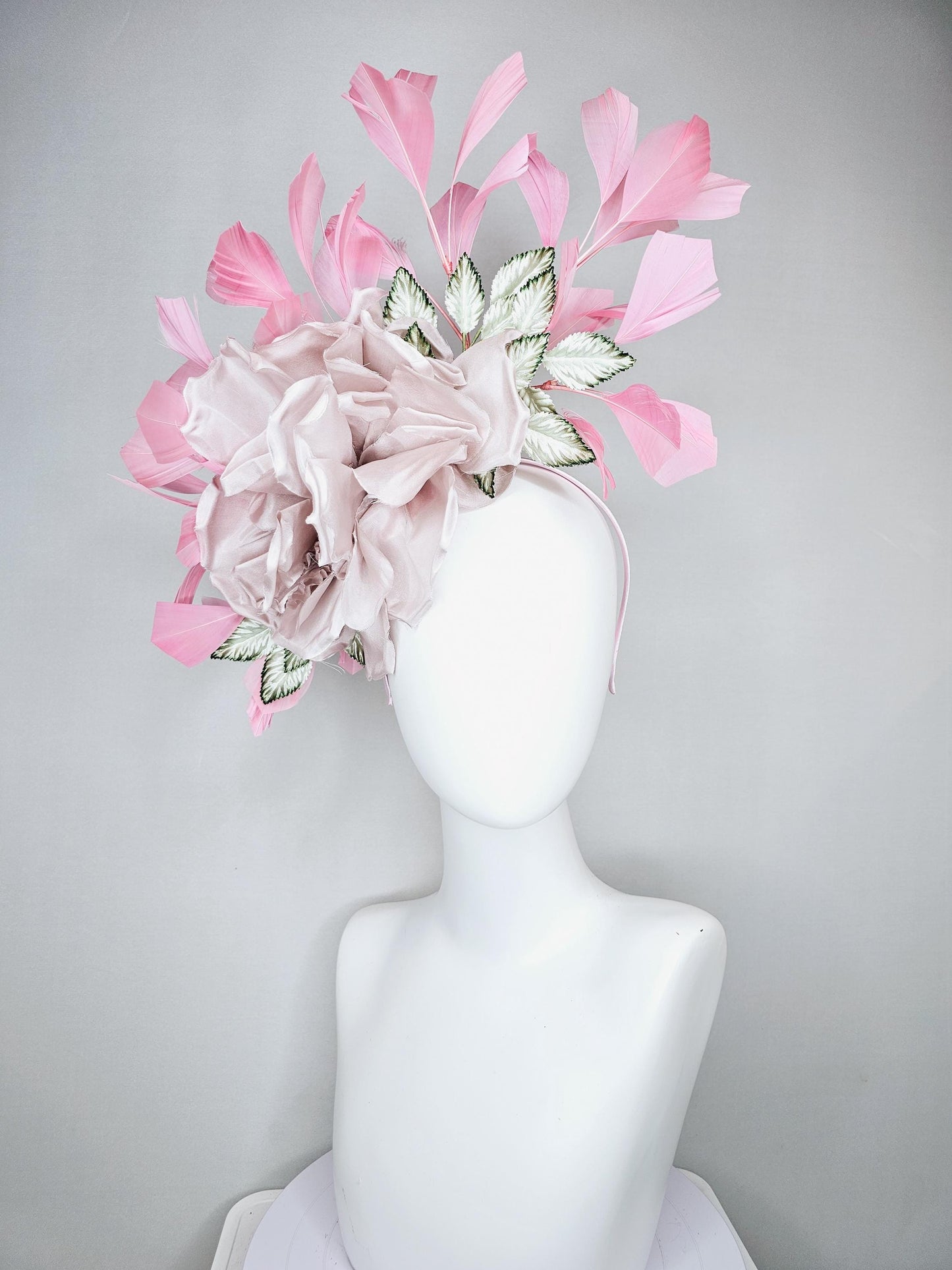 kentucky derby hat fascinator light dusty pink rose satin silk flower, white and green satin leaves and light baby pink branching feathers