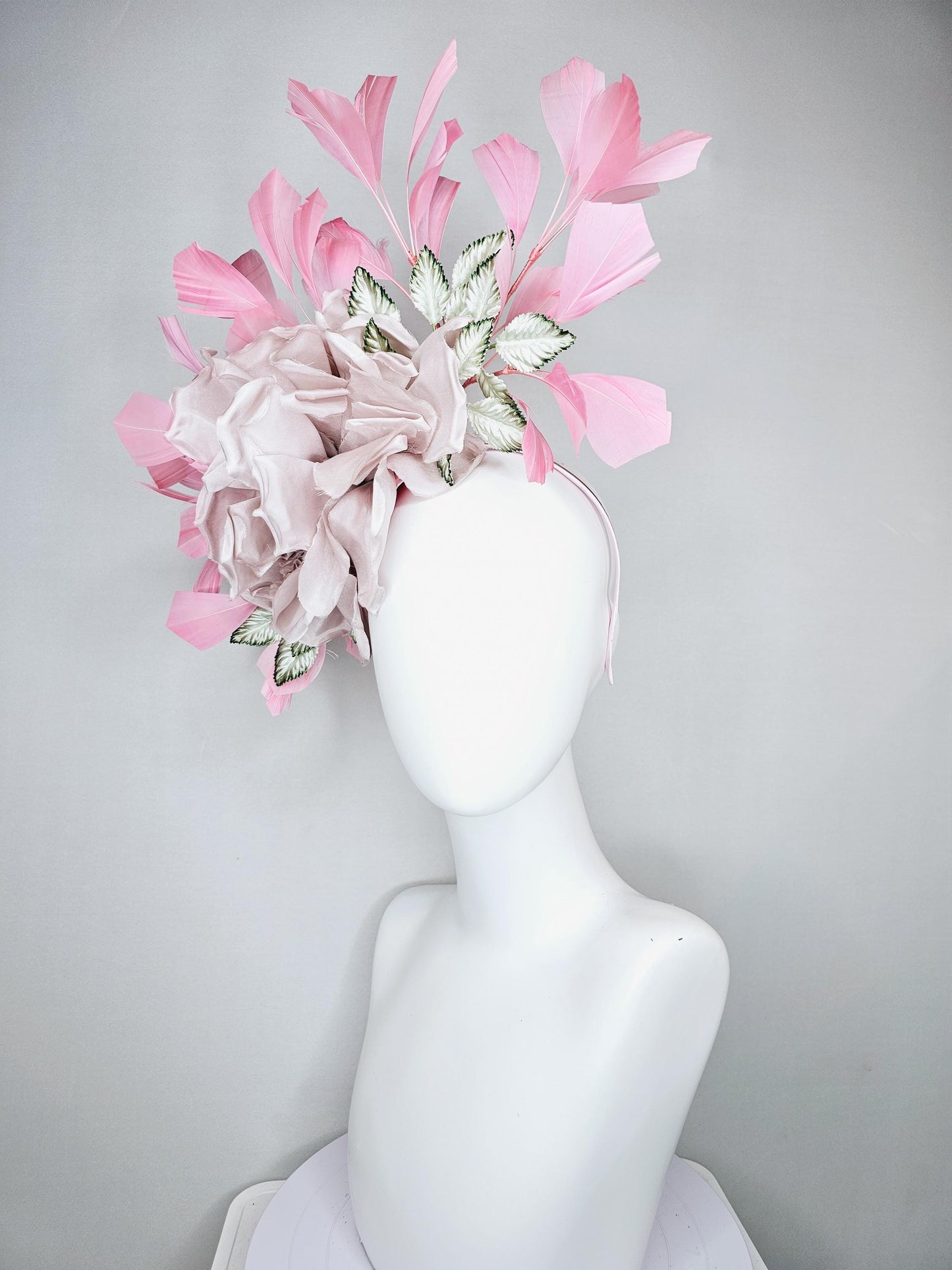 kentucky derby hat fascinator light dusty pink rose satin silk flower, white and green satin leaves and light baby pink branching feathers