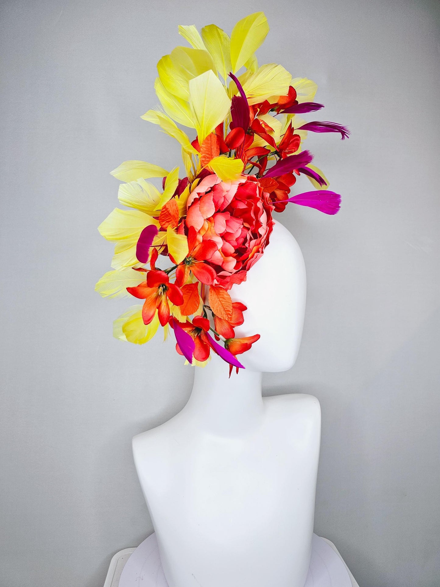 kentucky derby hat fascinator coral orange silk satin flowers with orange satin leaves, yellow and pink branching feathers on thin headband